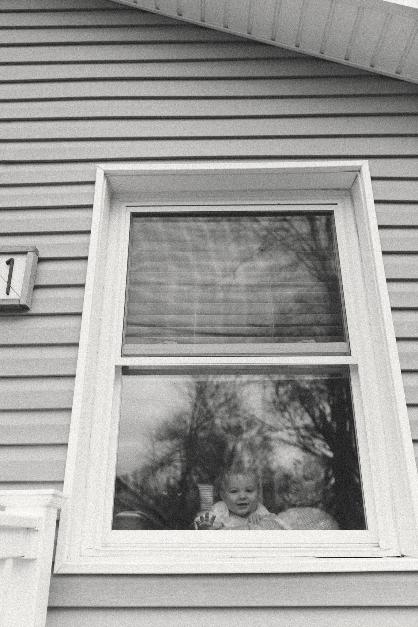 Progressive black and white photos showing views through exterior windows of a house.
