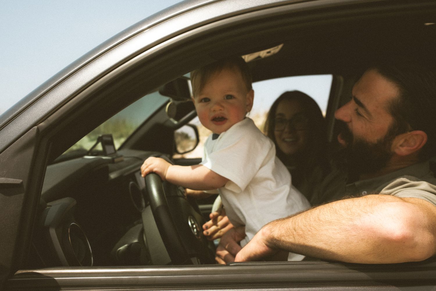 Series of photos taken from inside a car showing interactions through the vehicle windows.
