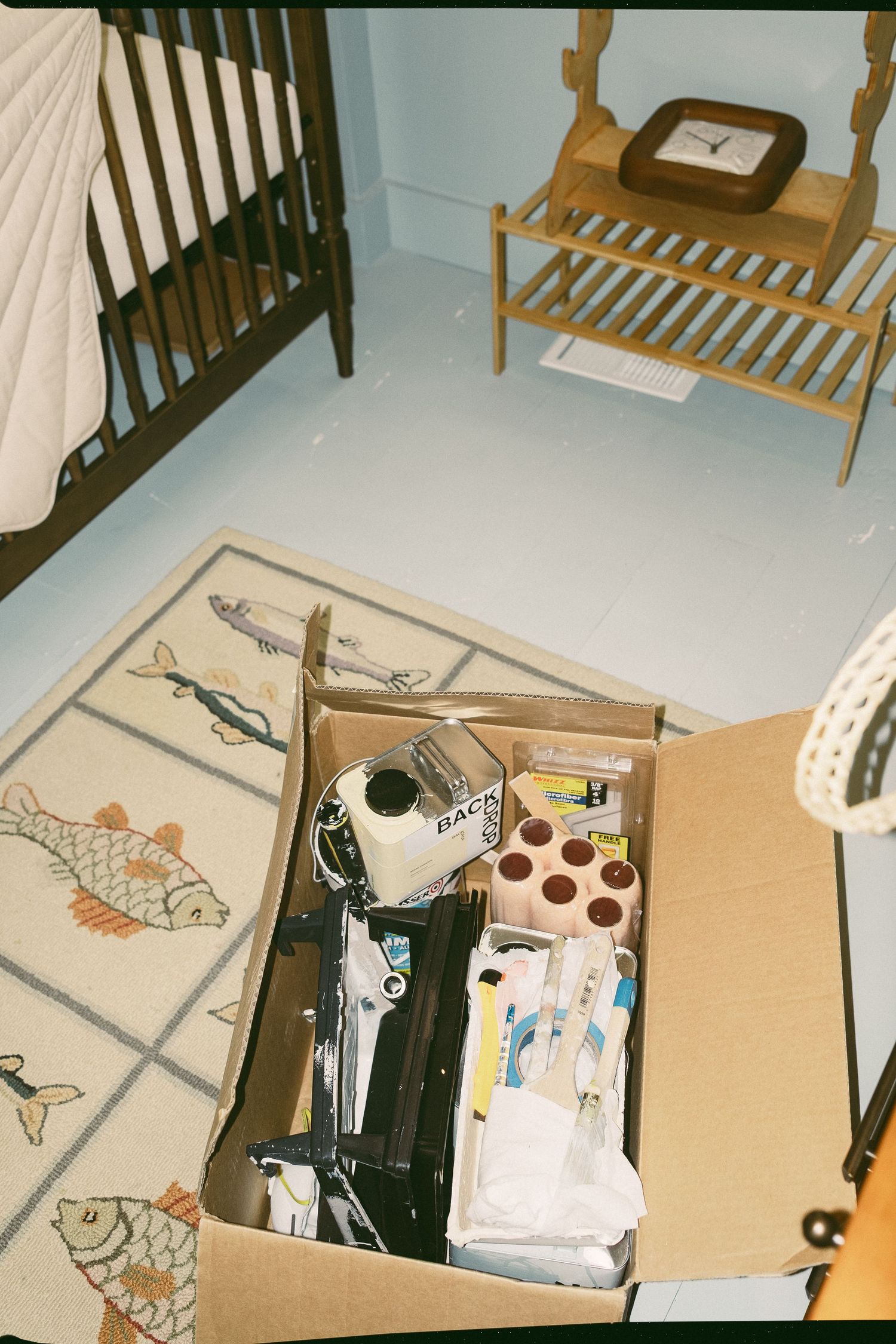 Collection of clothing and personal items laid out on wooden furniture.