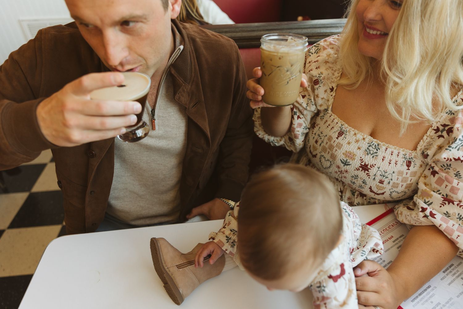 Candid family moments captured during coffee and conversation.