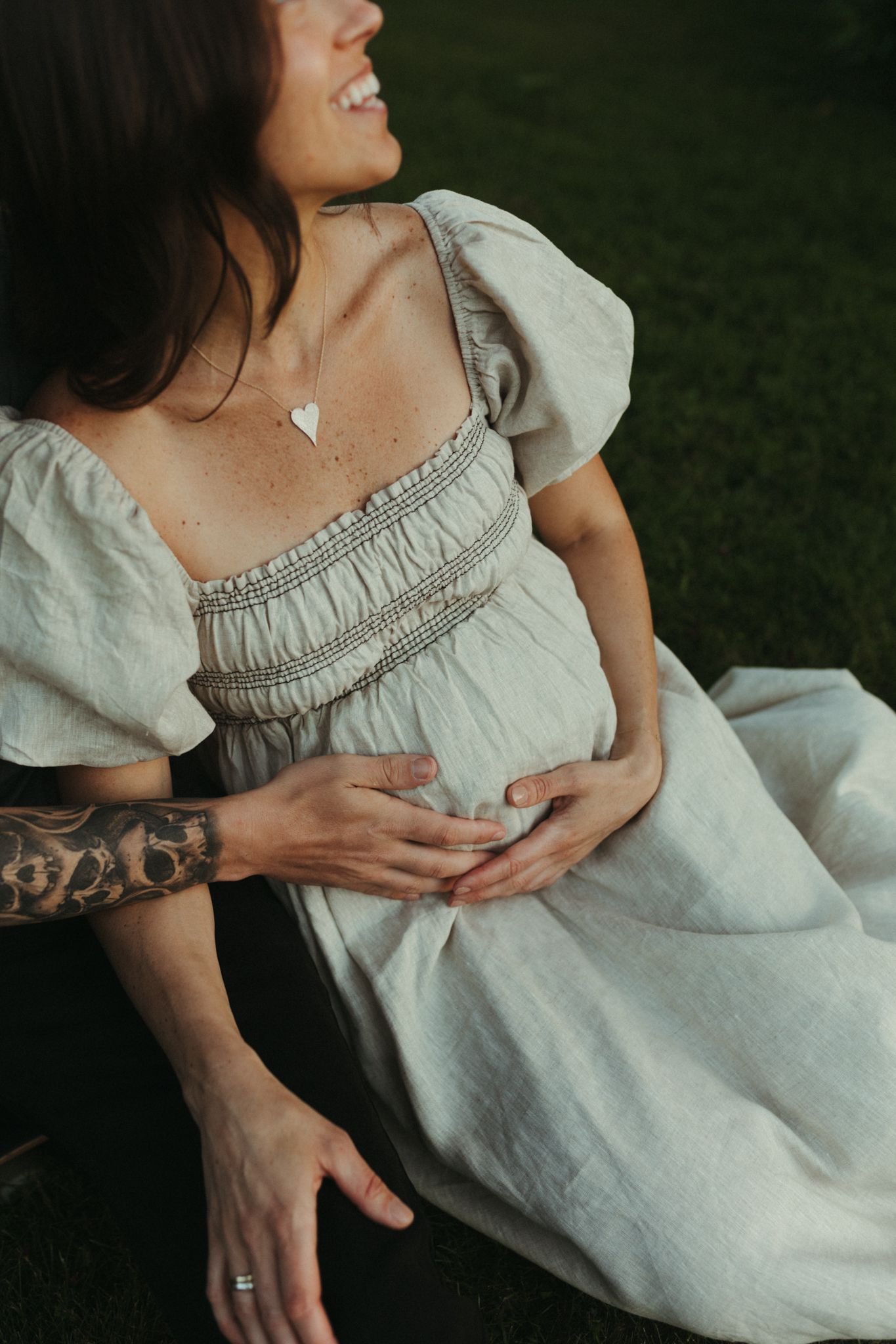 Close-up details of a light-colored linen dress with gathered neckline and ruffled sleeves.
