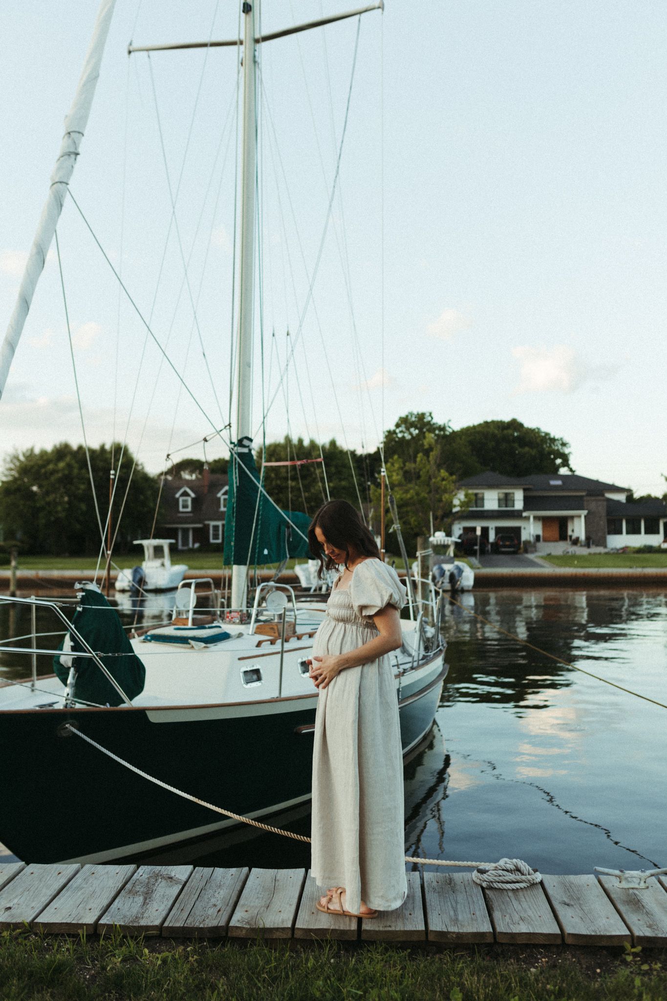 Expecting mother infront of sailboat on Long Island