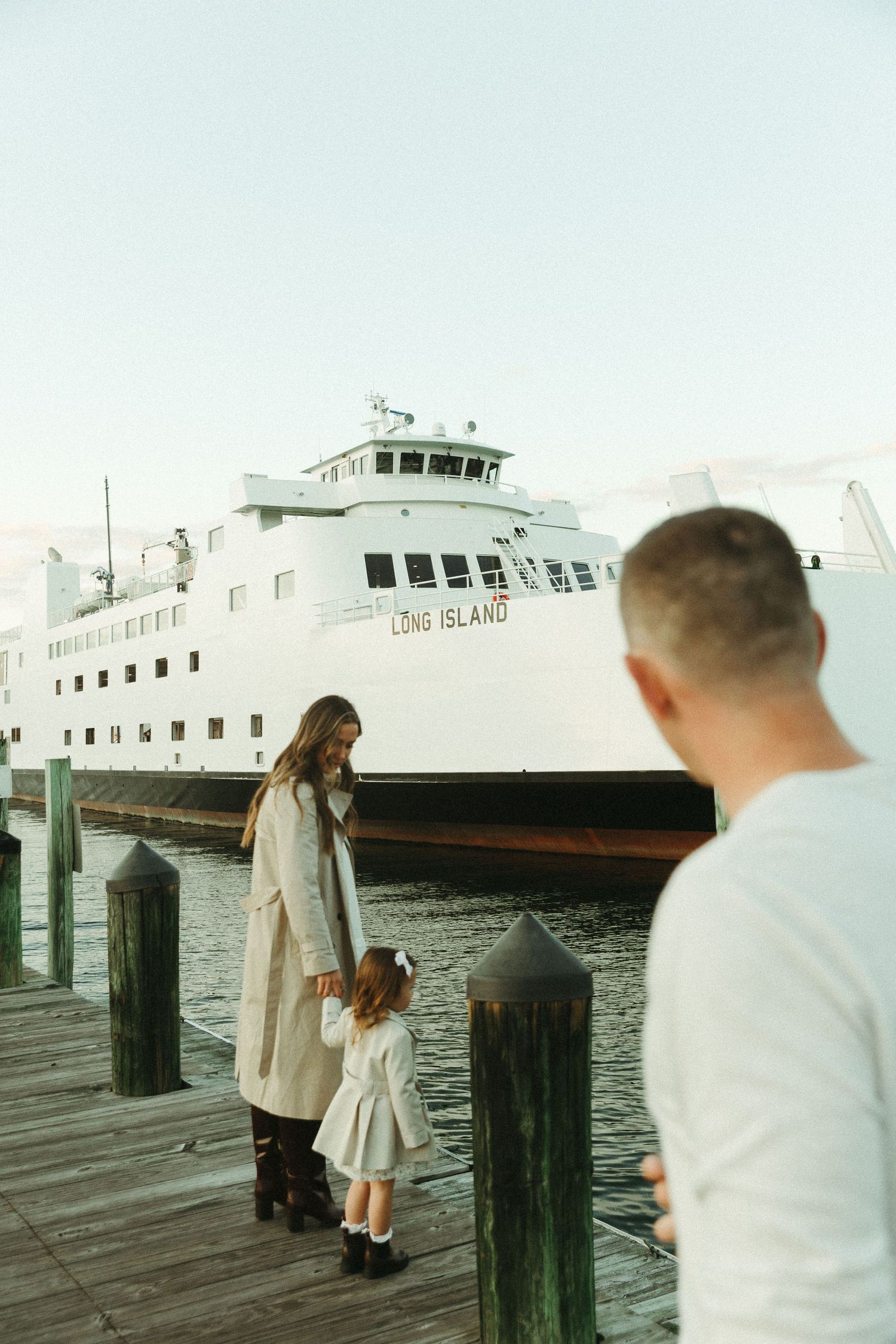 A wooden dock with a large white ferry boat labeled 'OAK ISLAND' in the background.