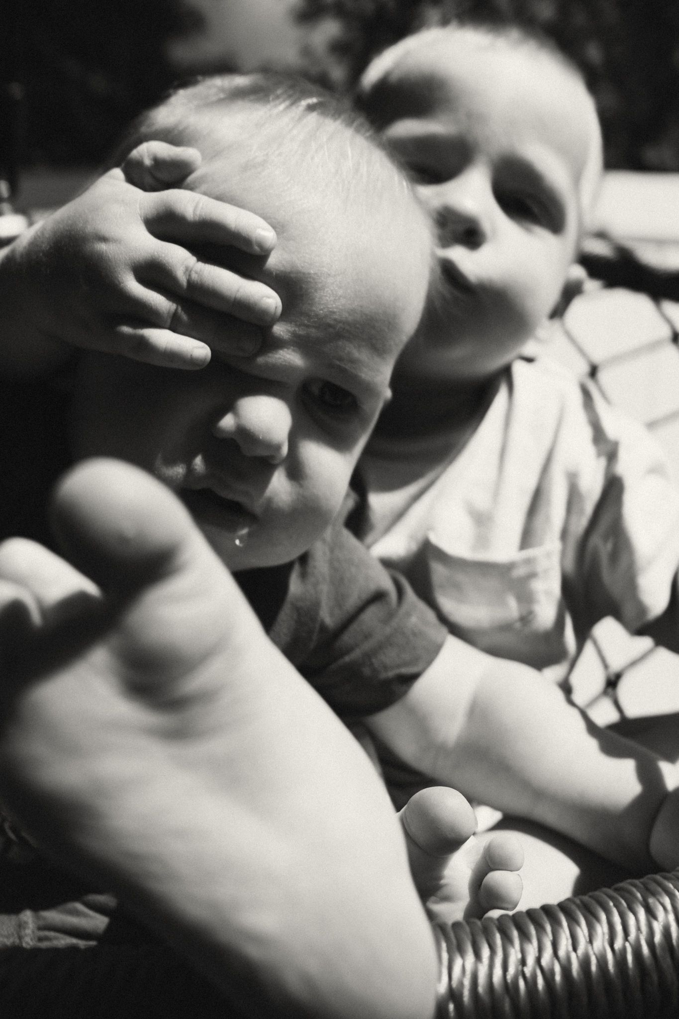 Black and white close-up artistic photography of small hands and textures.