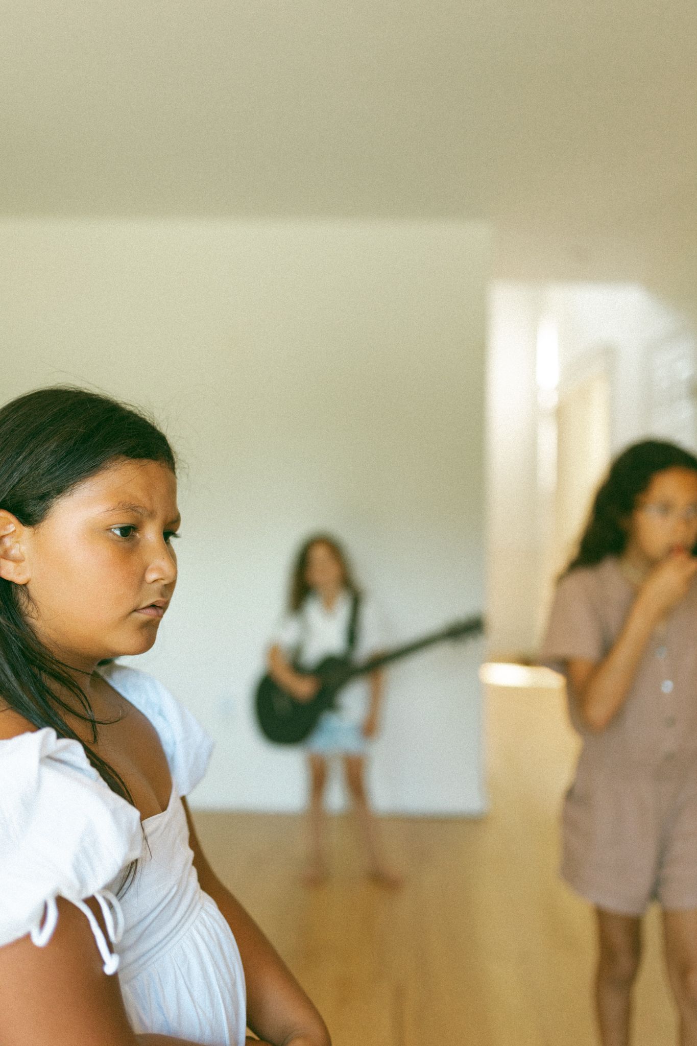 sisters, playing guitar