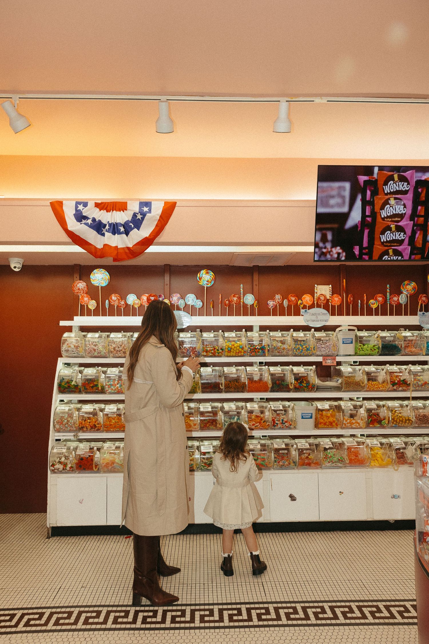 Wide view of candy store with vintage-style displays and decorative border tile.