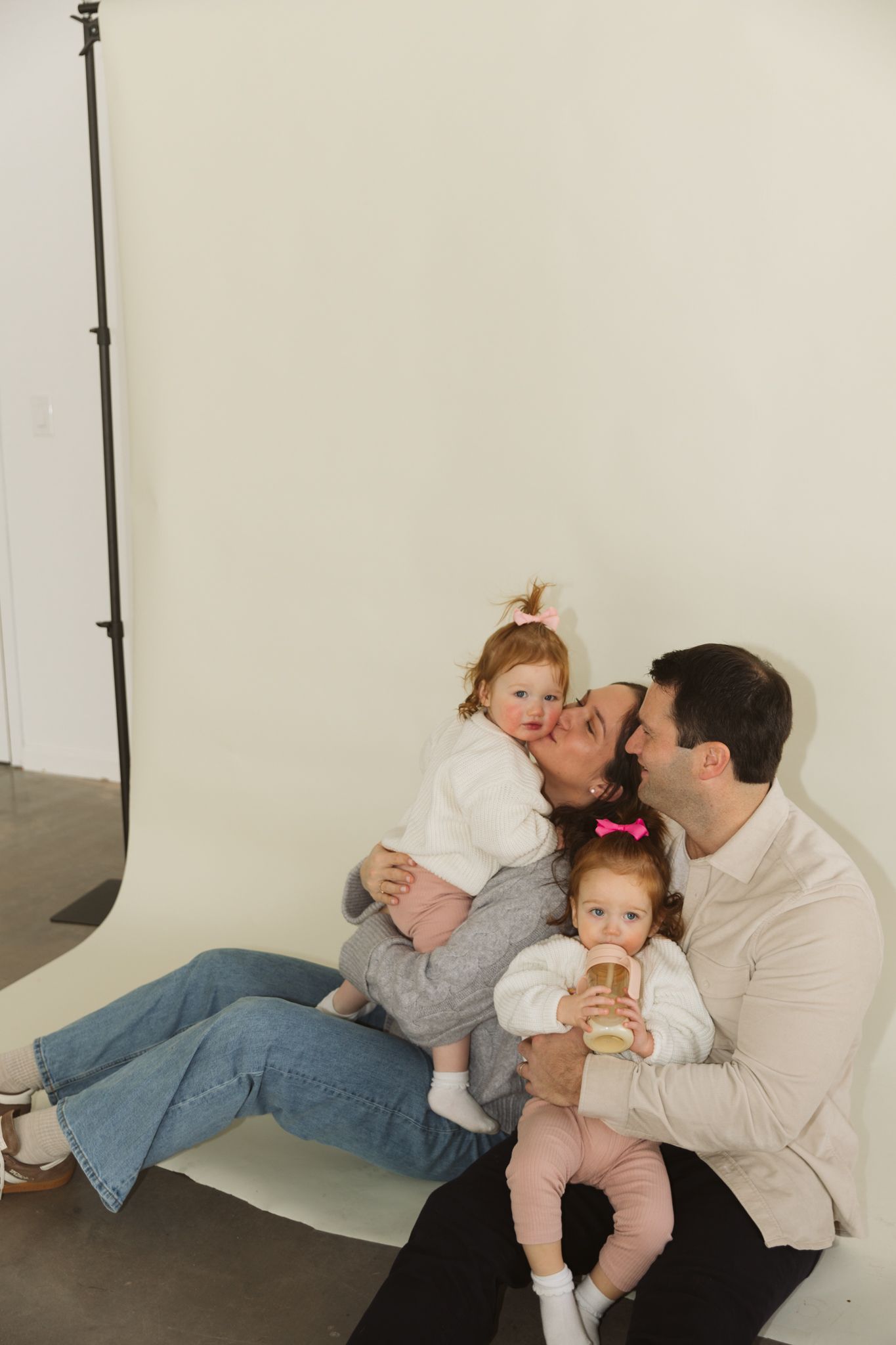 A series of candid family moments showing playful interaction between parent and child against a white background.