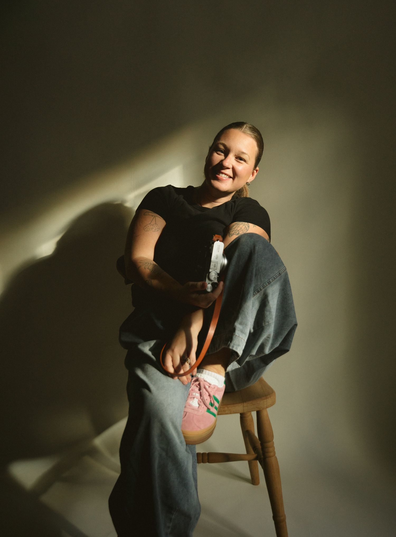 Dramatic lighting illuminates intimate family moments in a dark room.