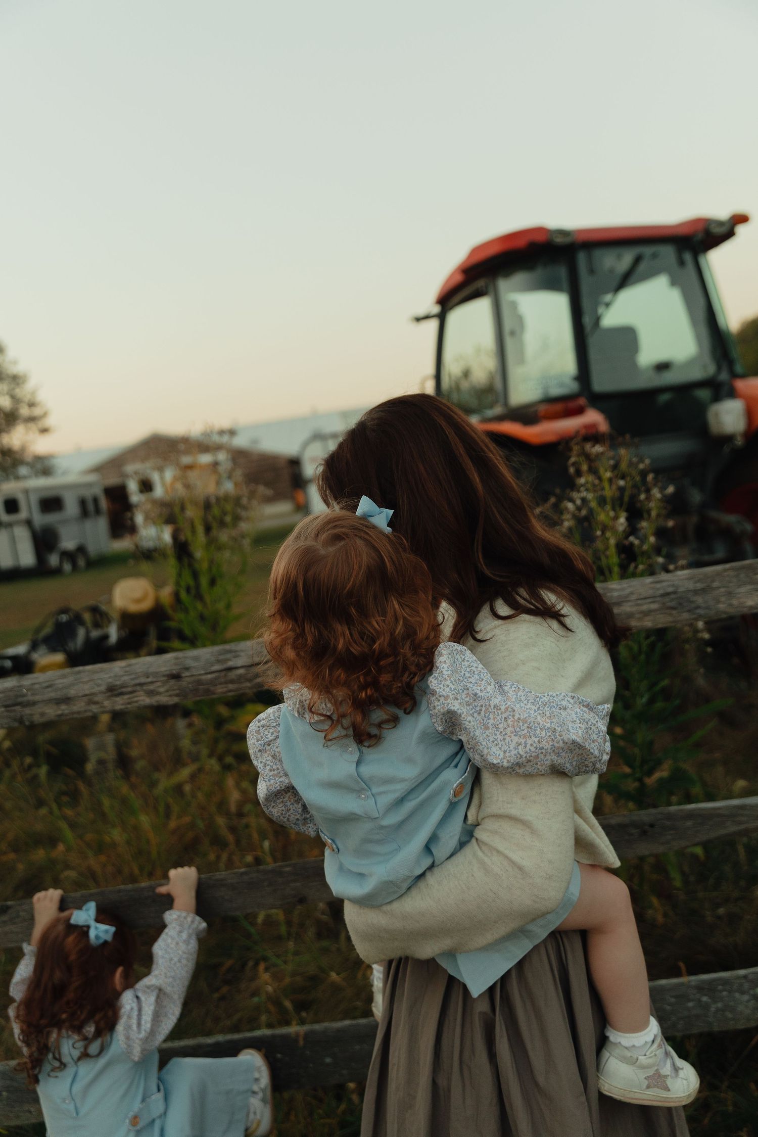 Sunset silhouette series showing embraces against farm equipment backdrop.