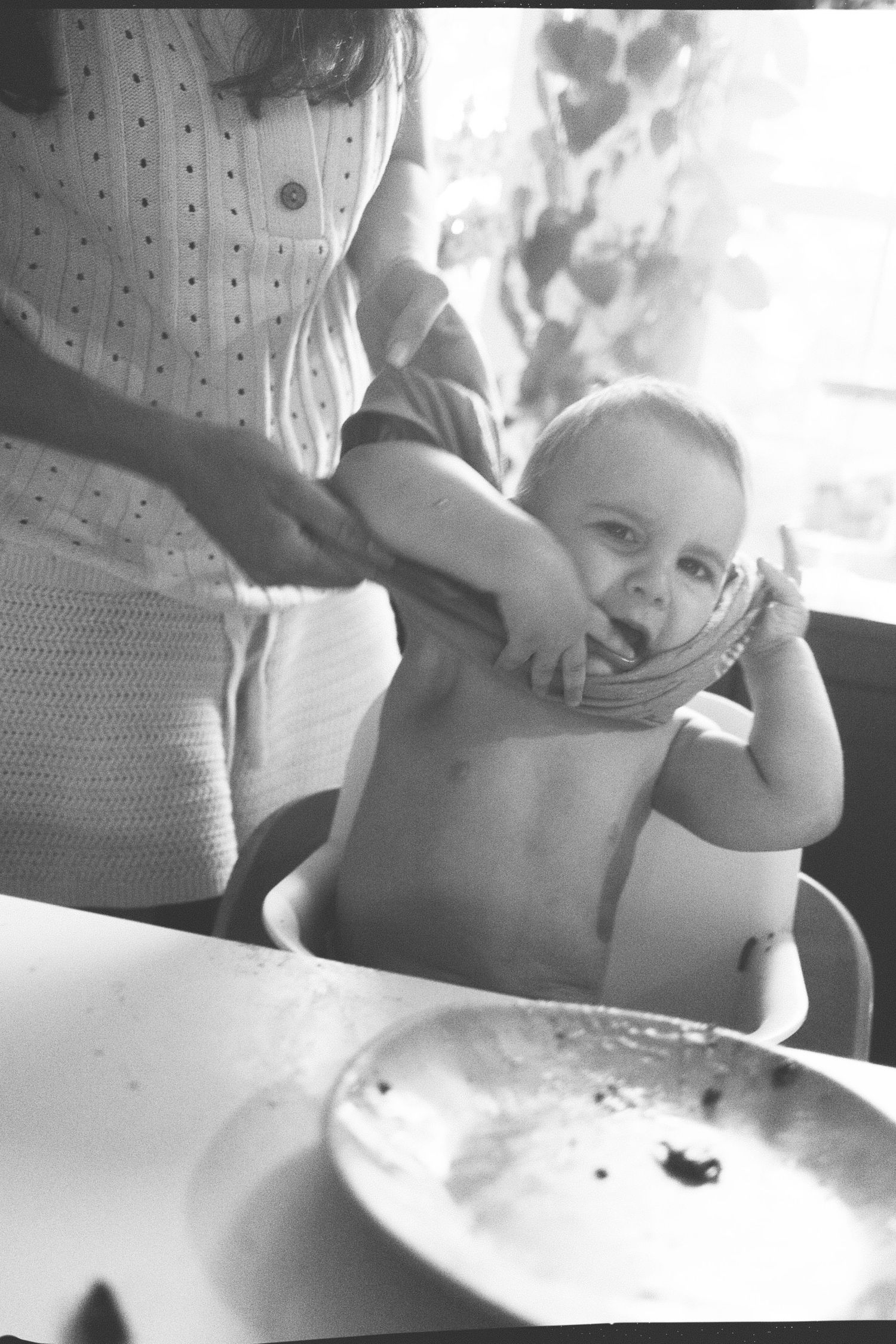 Series of black and white close-up shots showing gentle interaction with a small child.