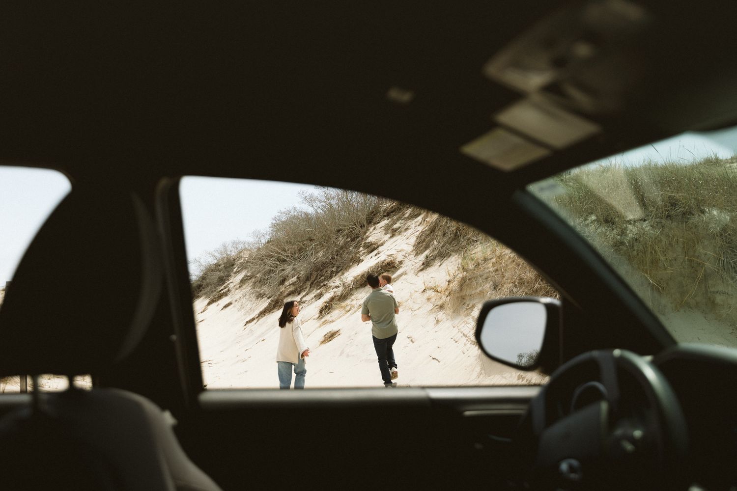 Interior car shots showing glimpses through windows at a beach setting.
