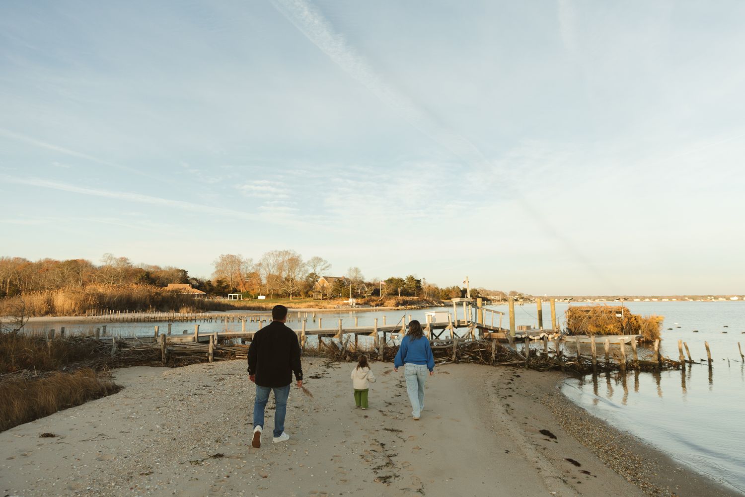 Panoramic view of coastal marina with docks and boats at sunset.