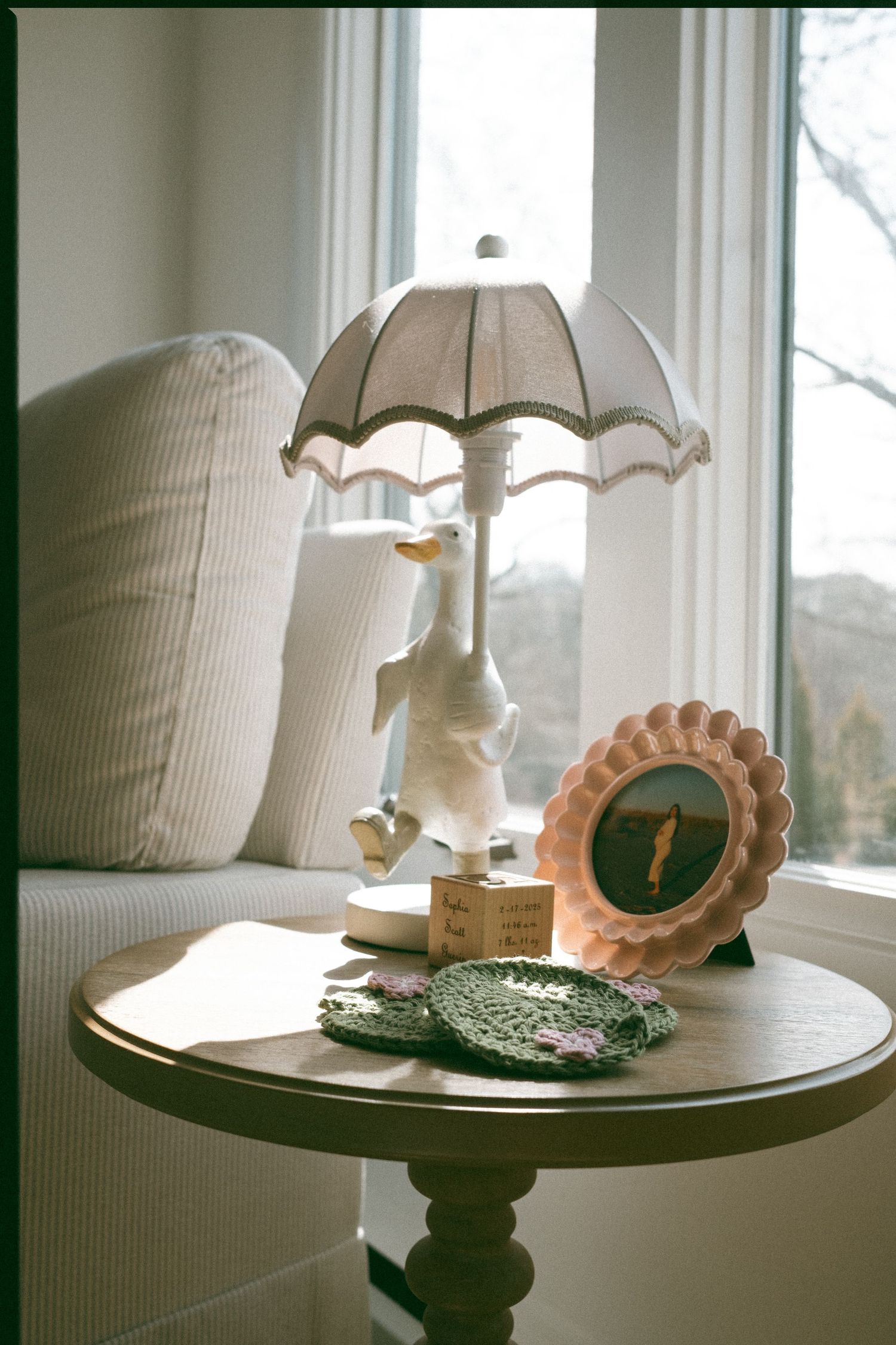 Vintage-style table display with white ceramic lamps and decorative shells.