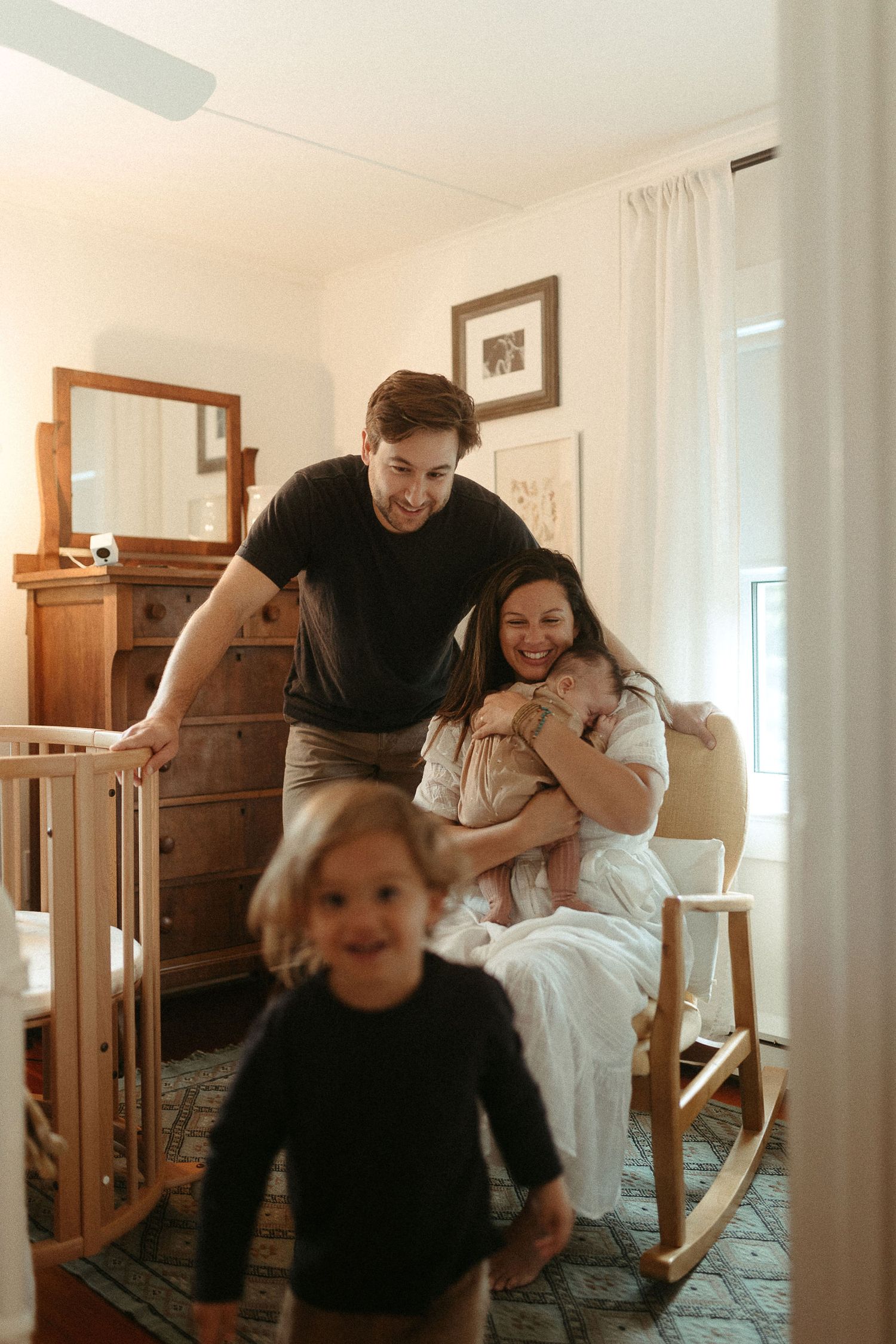 Playful family moments captured in a bright interior with wooden furniture.