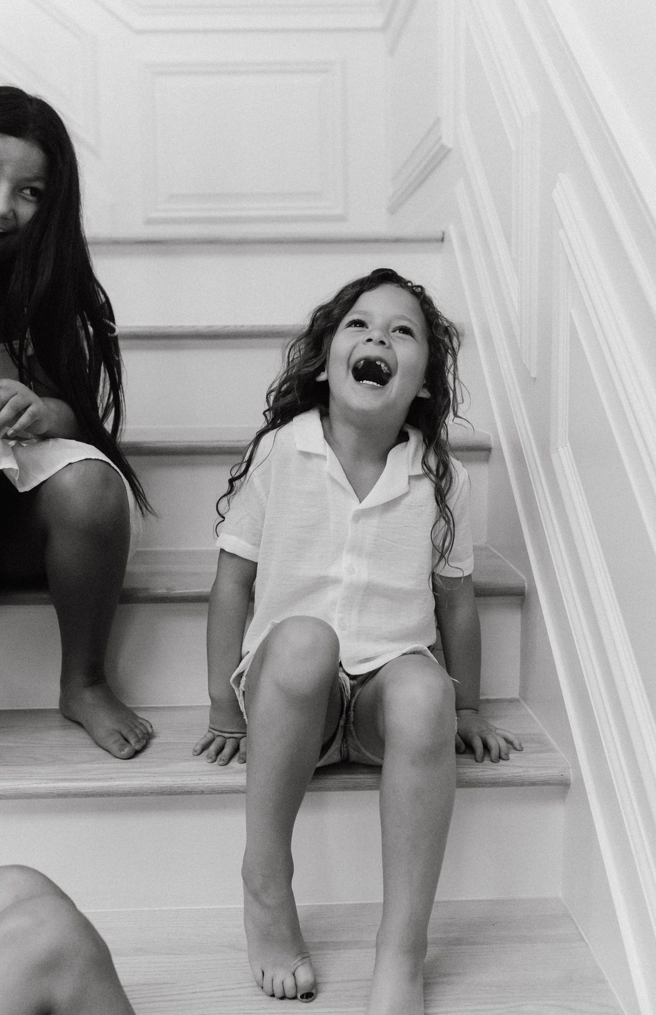 girl sitting on staircase laughing