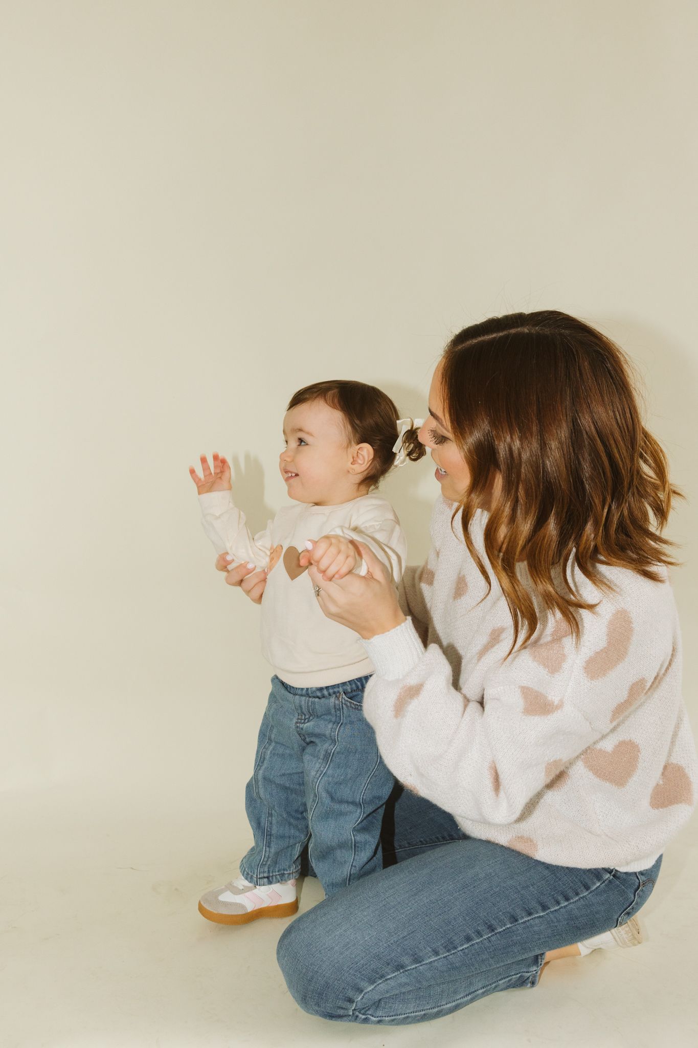 Candid sequence of family interaction showing movement and play against a neutral backdrop.