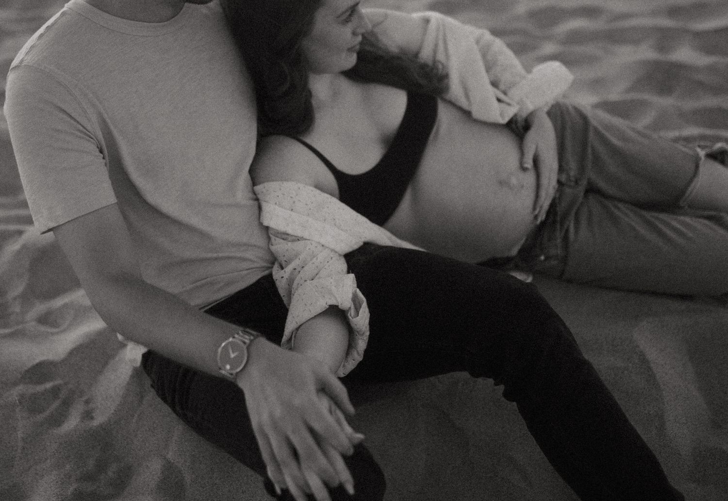 Black and white photo of intimate moments on a beach.
