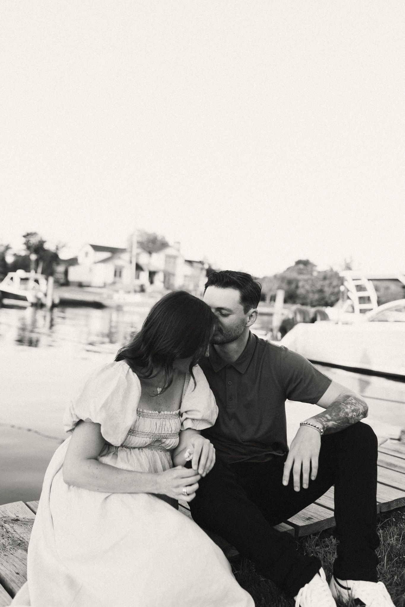 Black and white portraits of a couple sharing intimate moments outdoors.