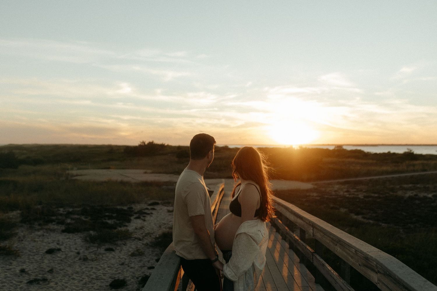 Romantic sunset silhouettes against a vast desert landscape.