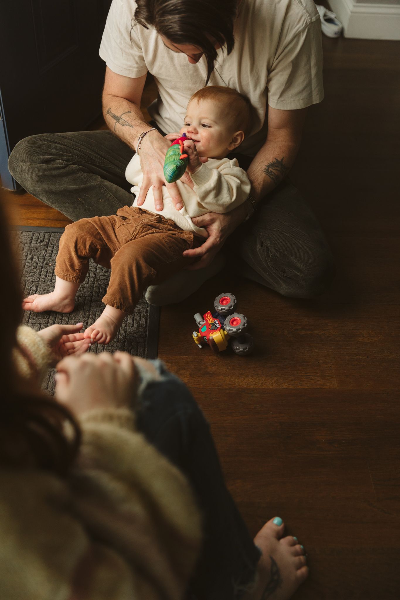 A series of dimly lit indoor photos showing playtime moments on hardwood floors.