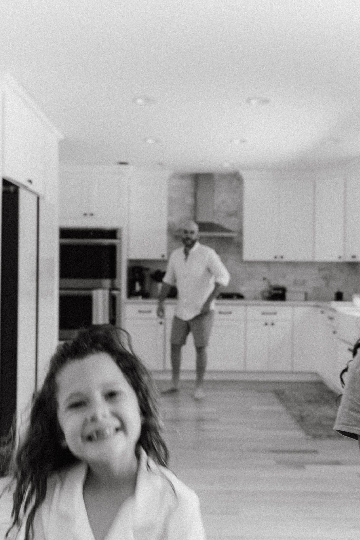 girl smiling with dad in the backround