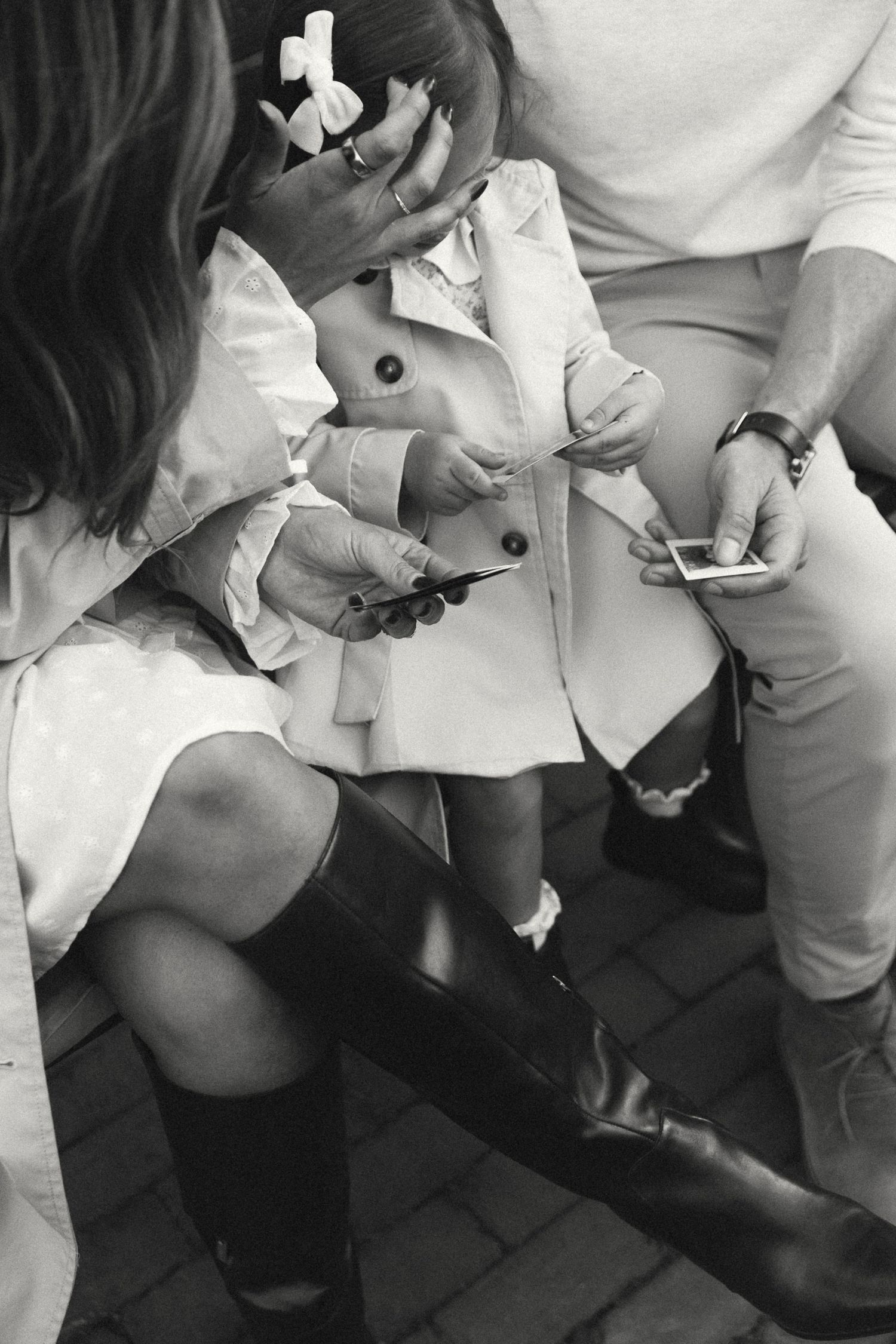 Black and white photo of formal shoes and dress details.