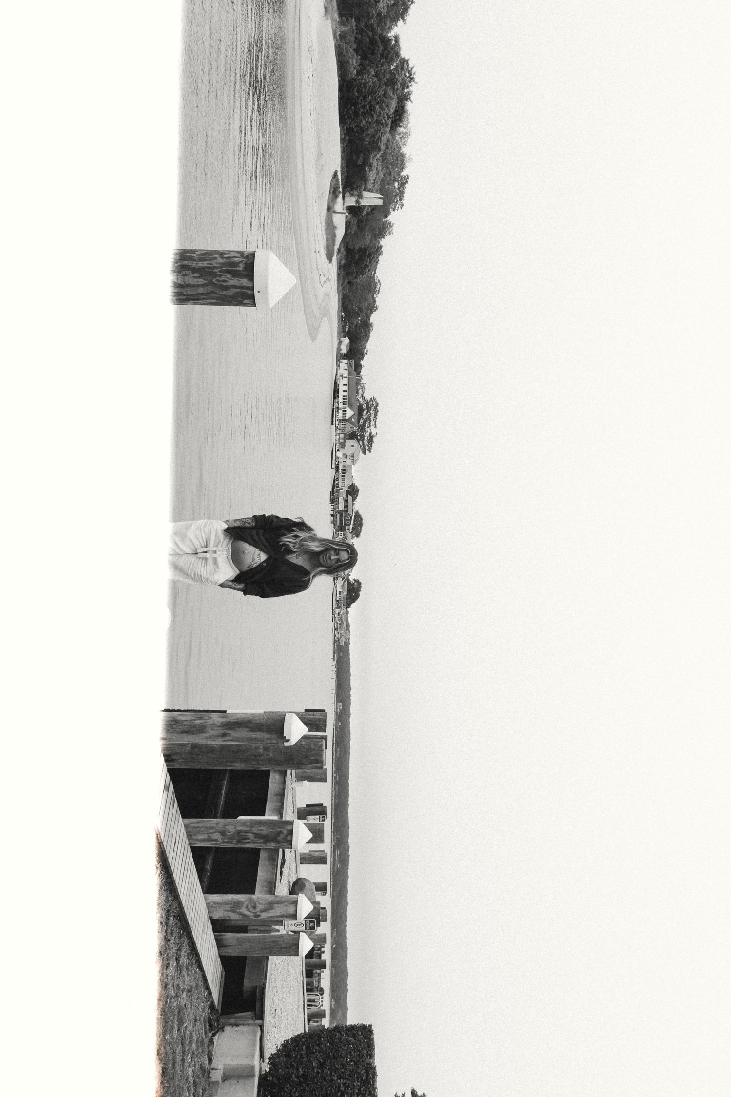 Black and white artistic landscape photo taken at tilted angle on waterfront.
