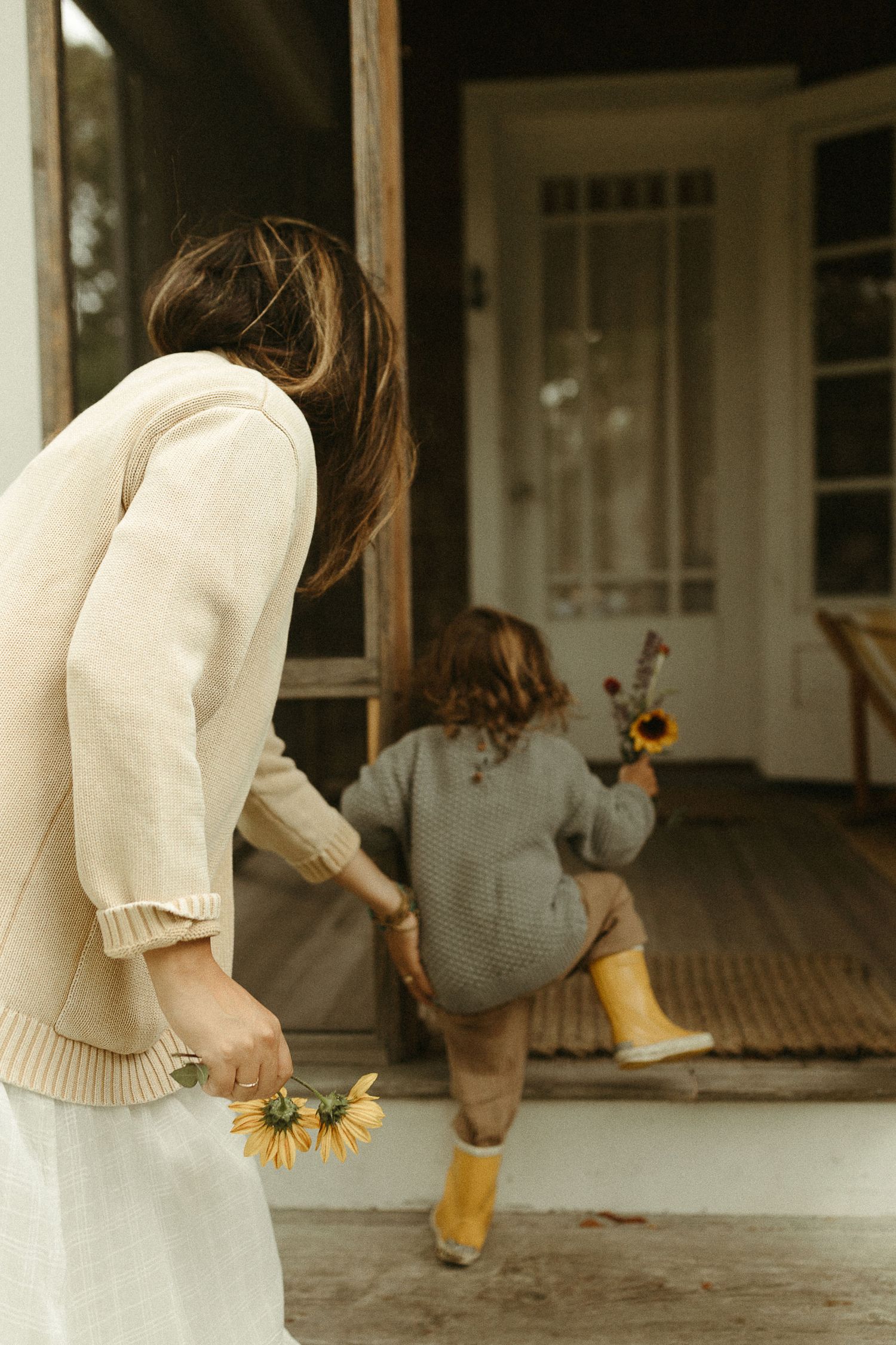 Sequence showing interactions near a white porch with sunflowers in view.