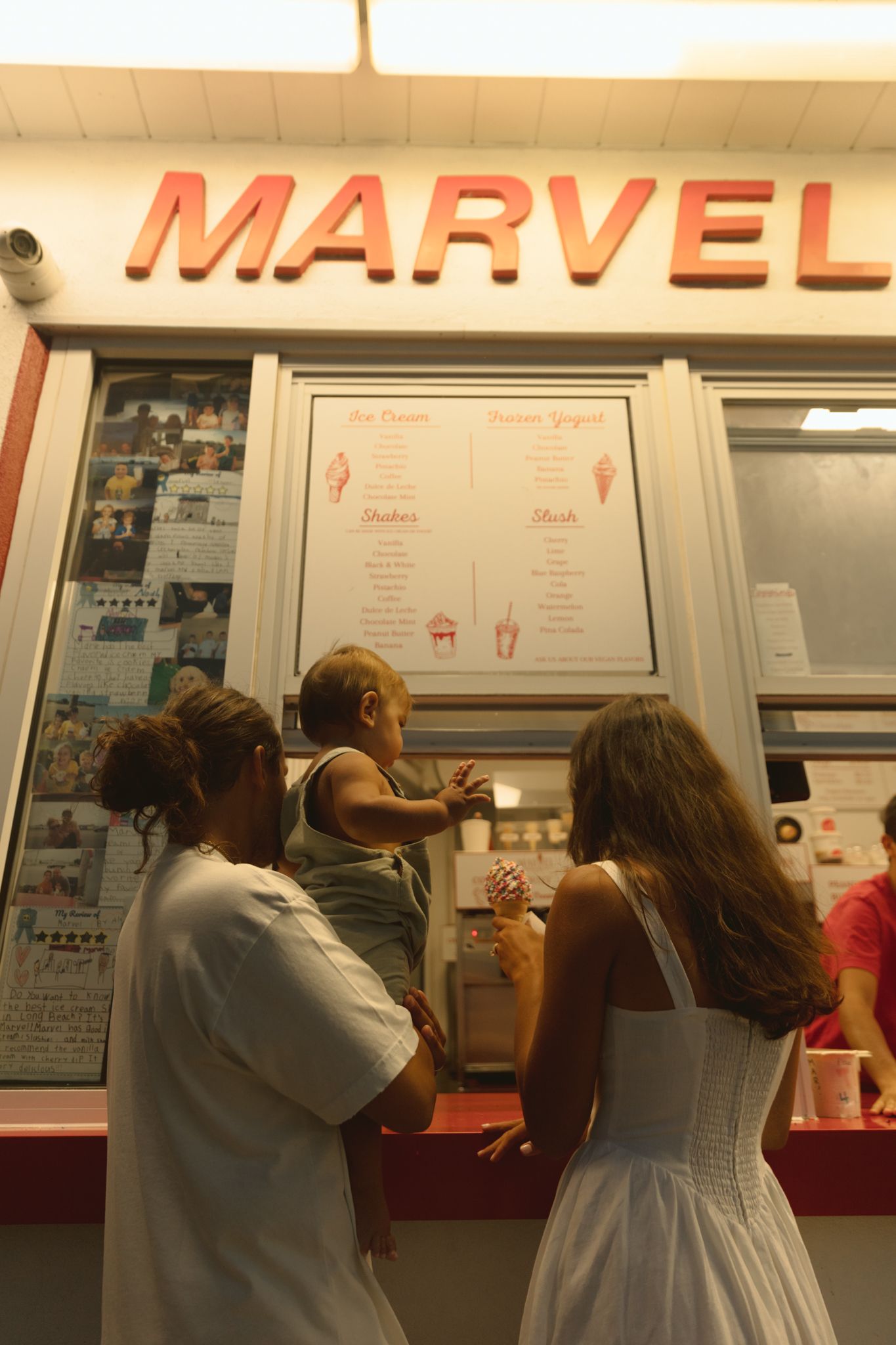 People waiting in line at Marvel restaurant counter during sunset.