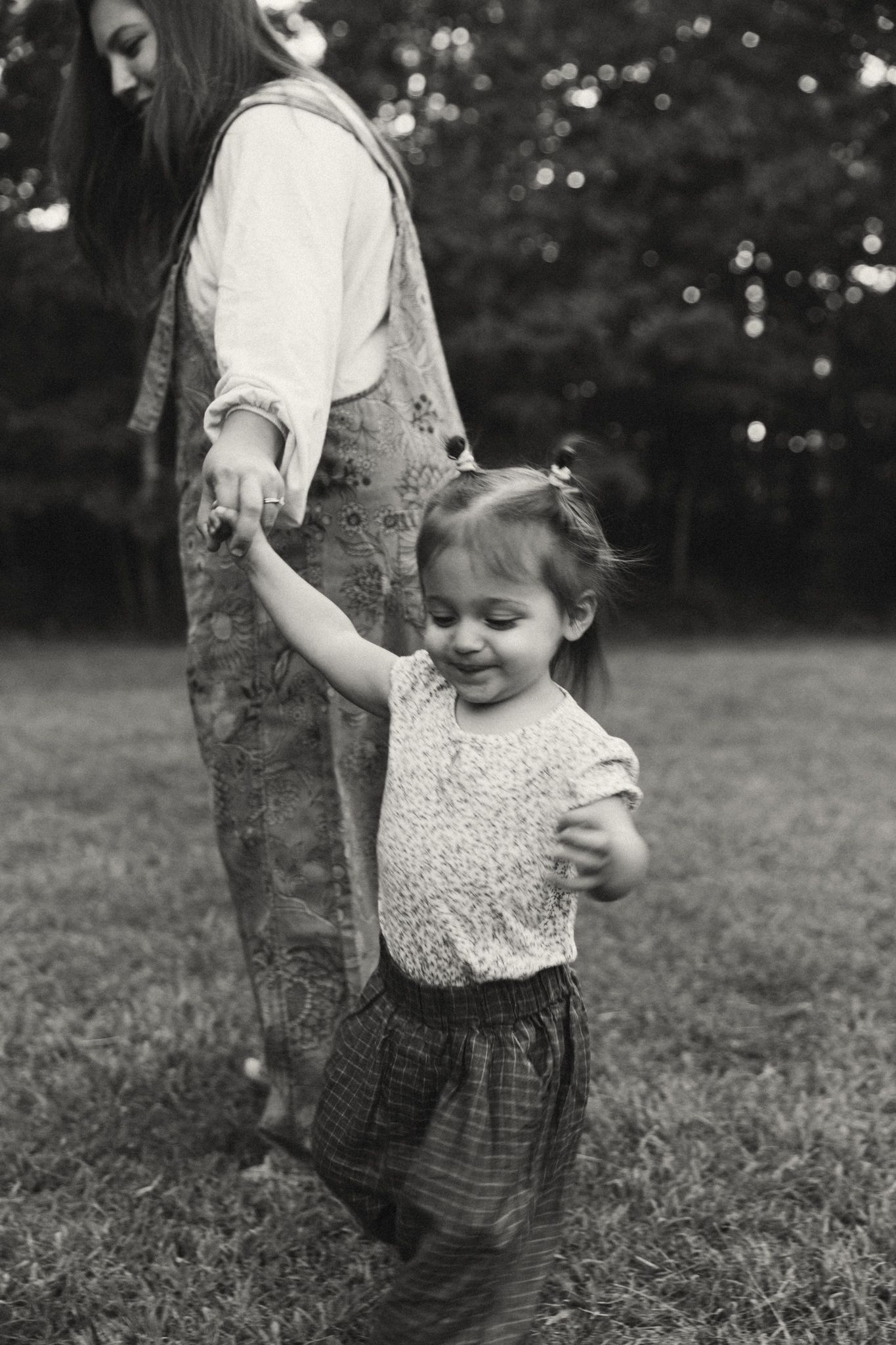 A black and white outdoor scene with movement captured in soft focus.