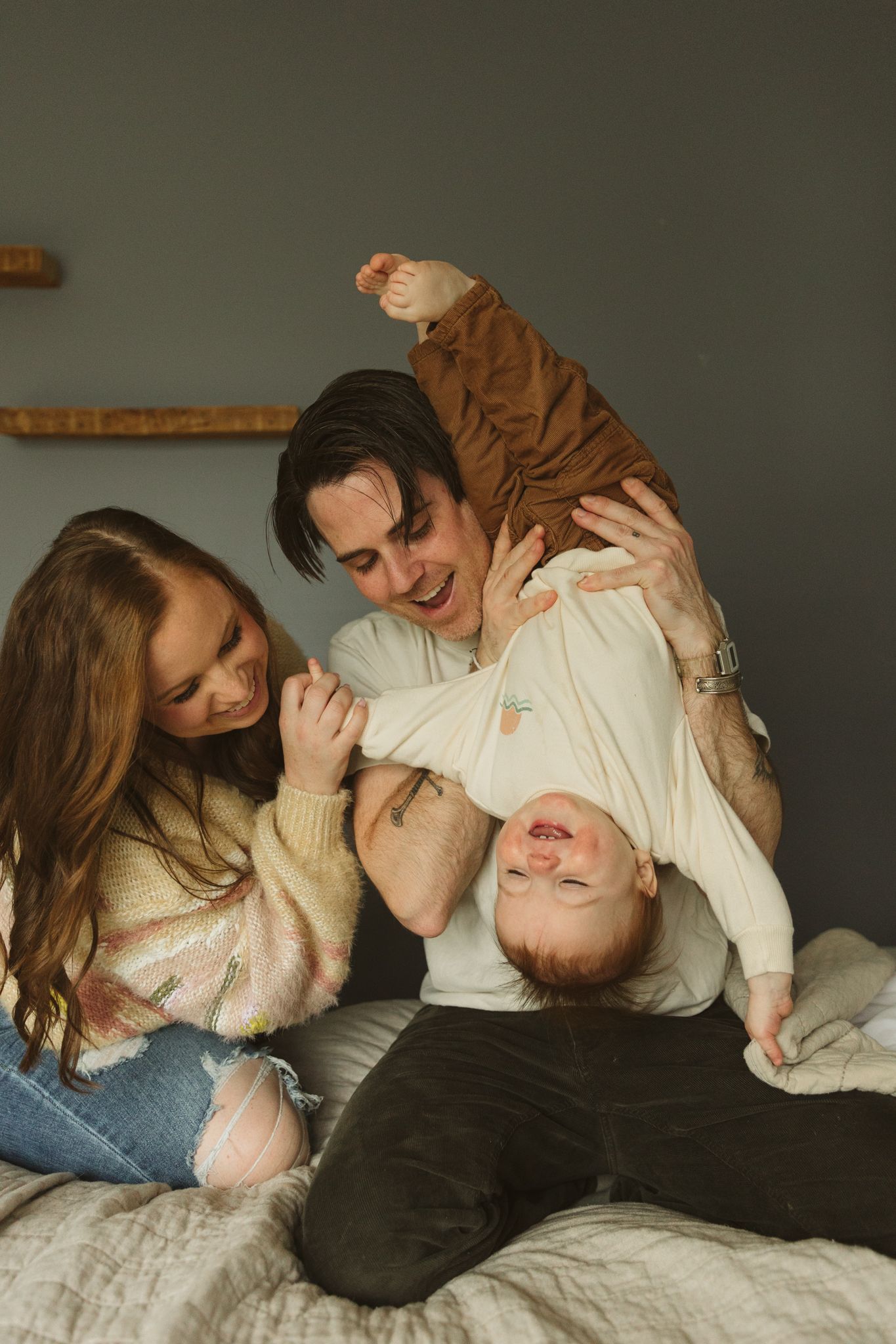 A joyful playtime scene on a comfortable bed.