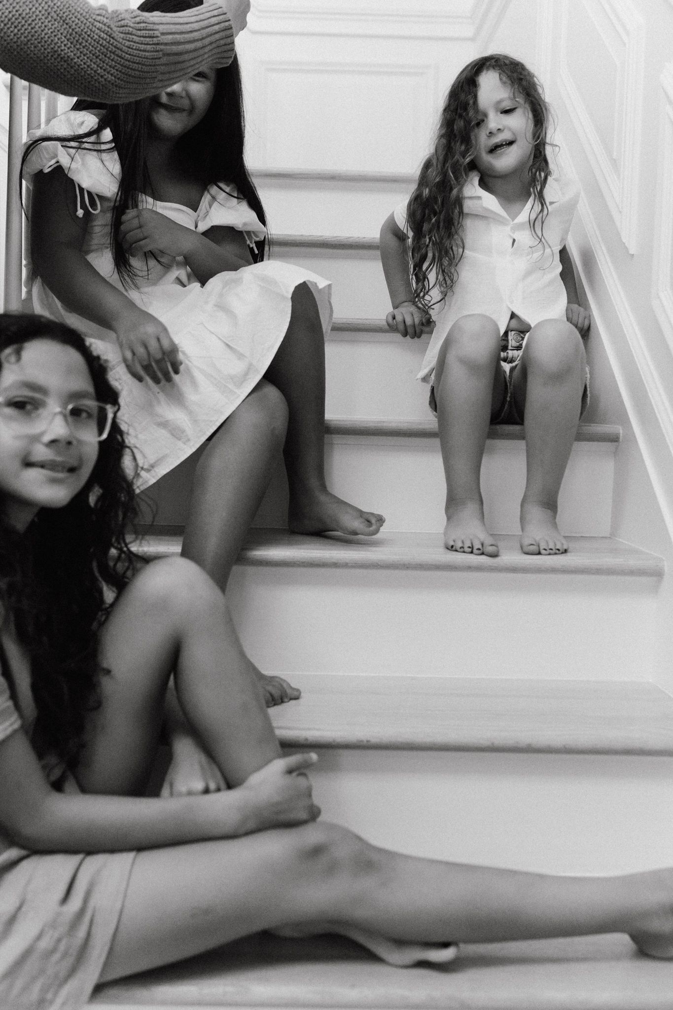 girls sitting on staircase, laughing