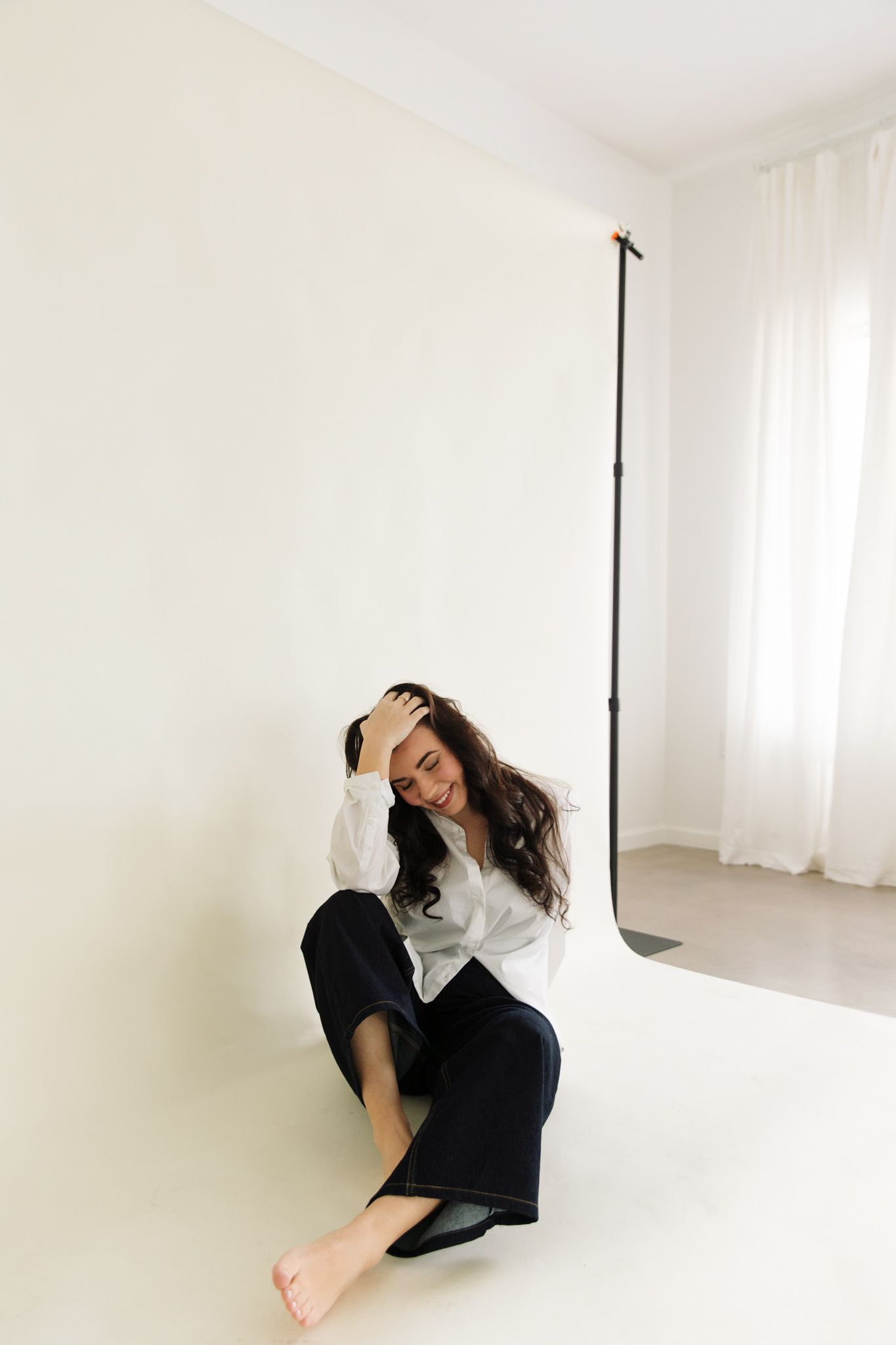 Artistic portrait series showing dynamic poses on a white studio floor.