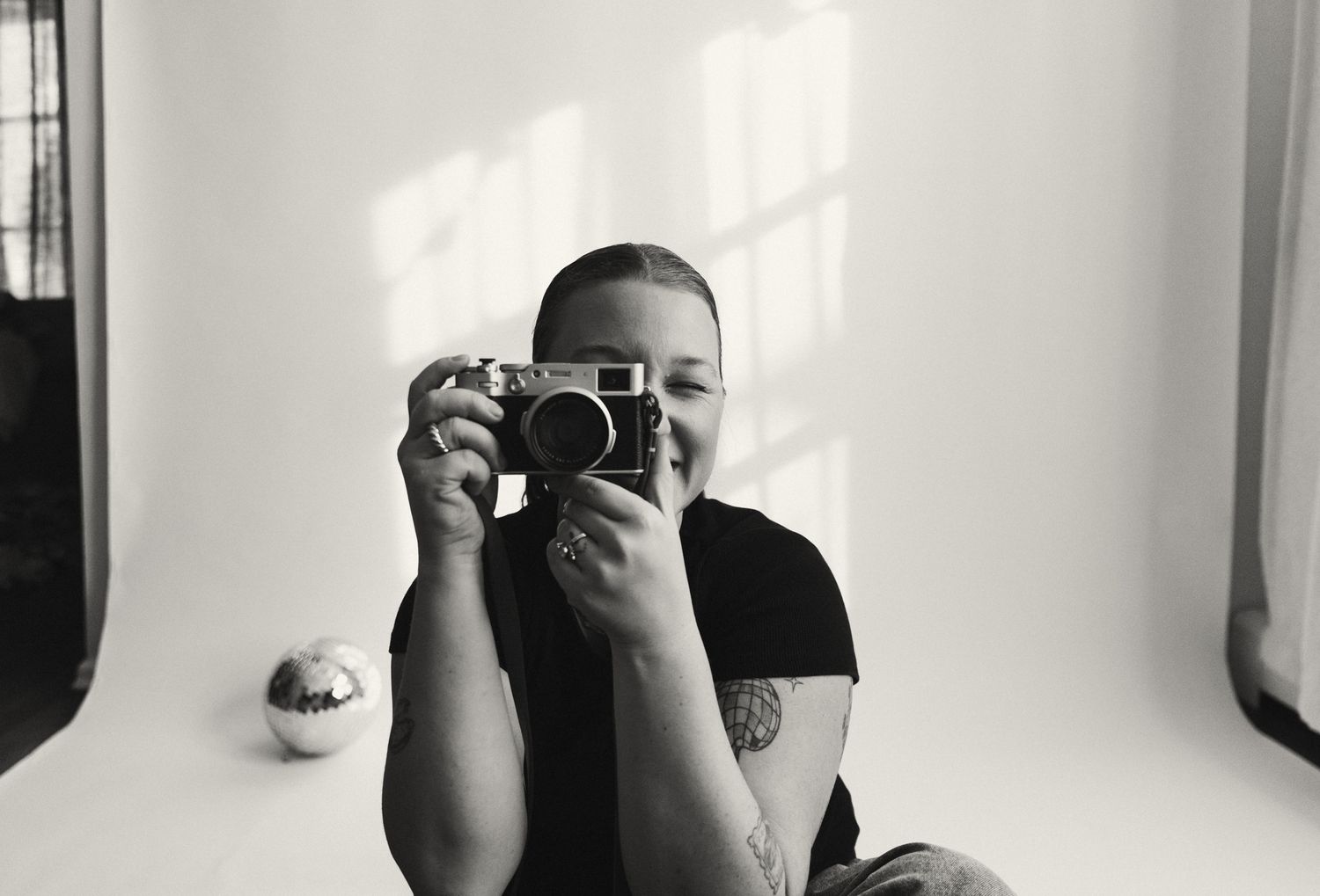 Black and white series showing someone taking photographs with a camera.