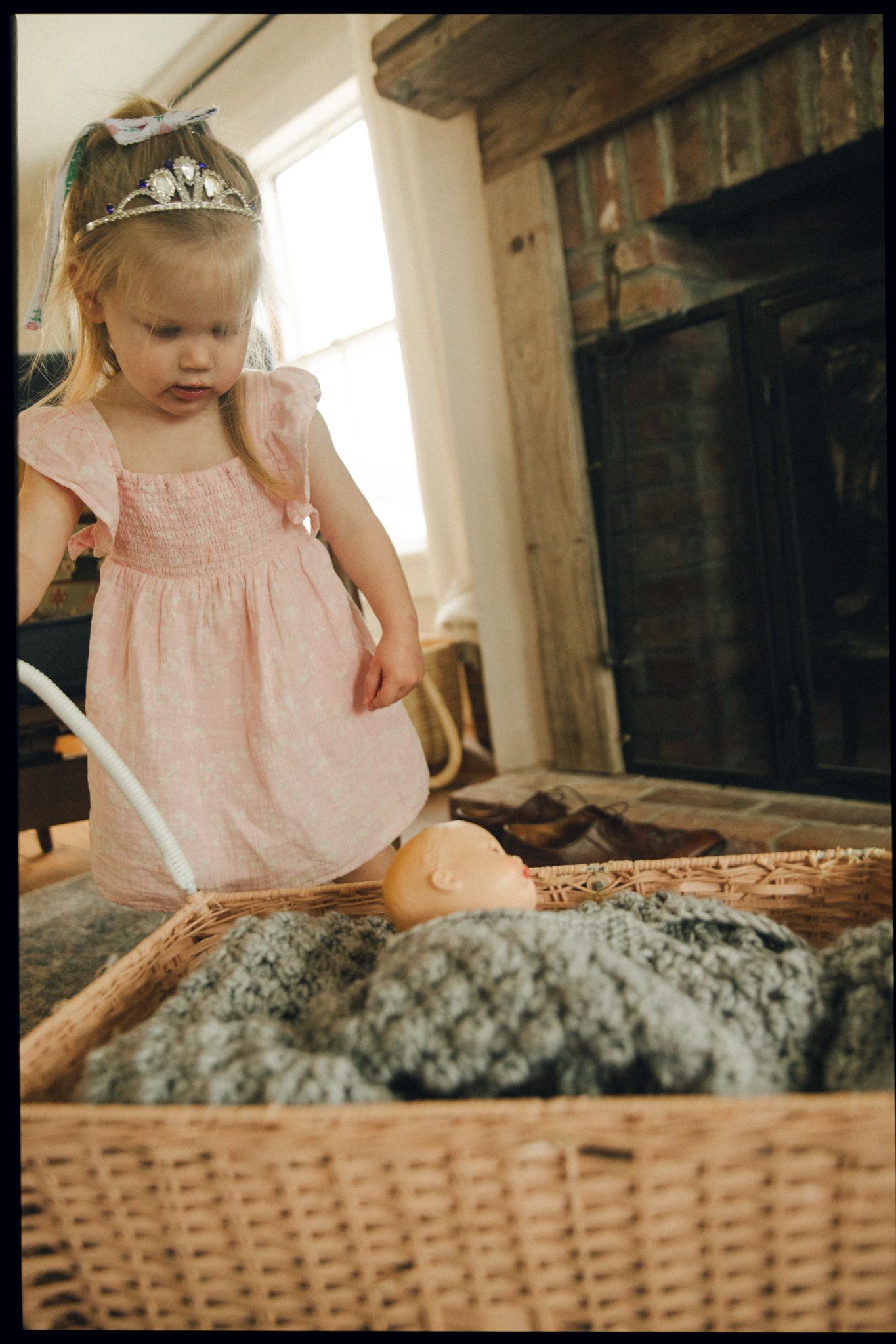 Pink clothing visible near a woven basket in warm, natural lighting.