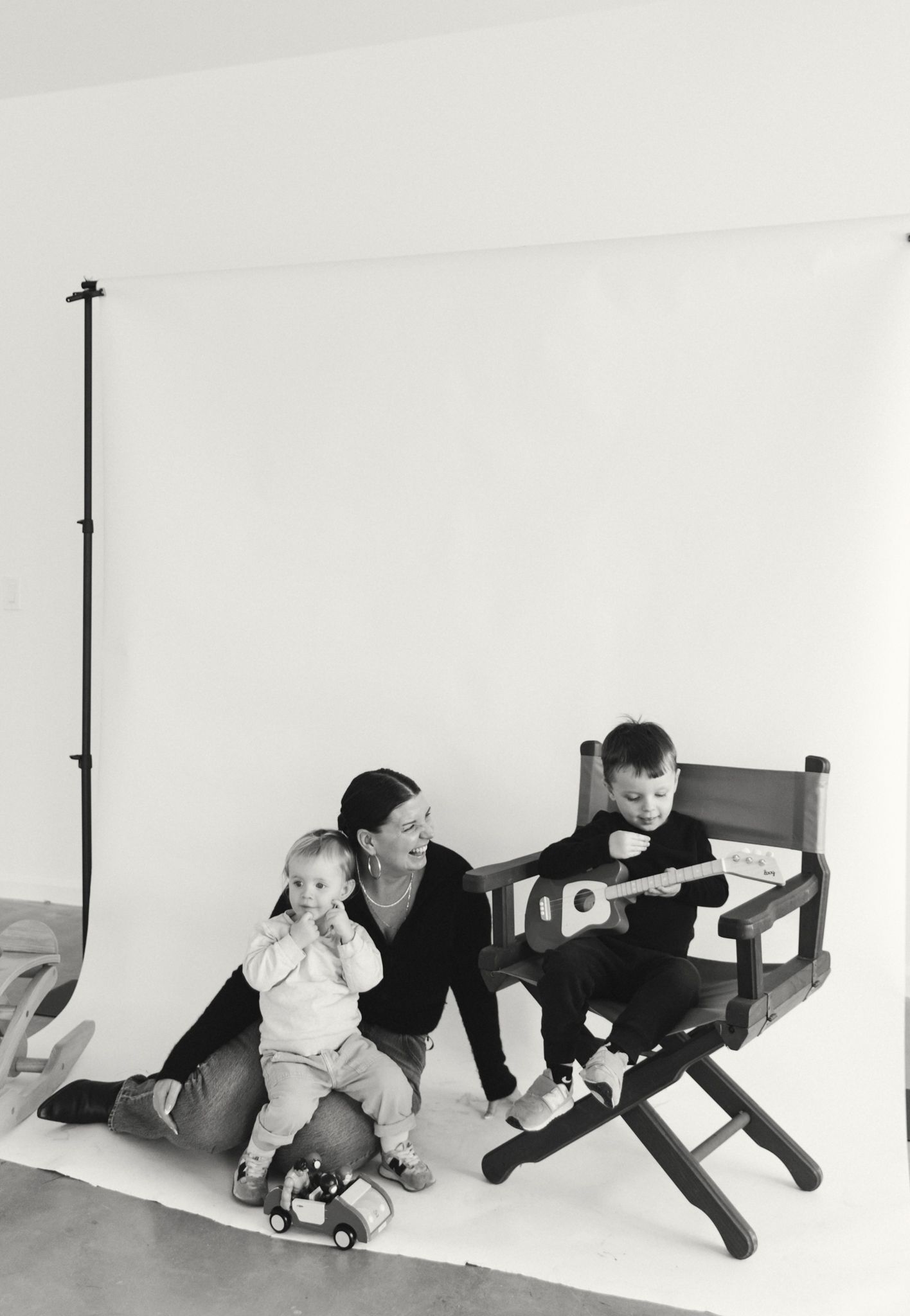 A series of playful black and white photos showing crawling movements across a white floor.