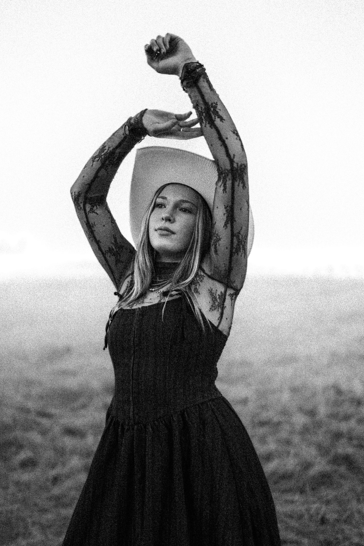 Artistic black and white senior girl portrait with expressive pose