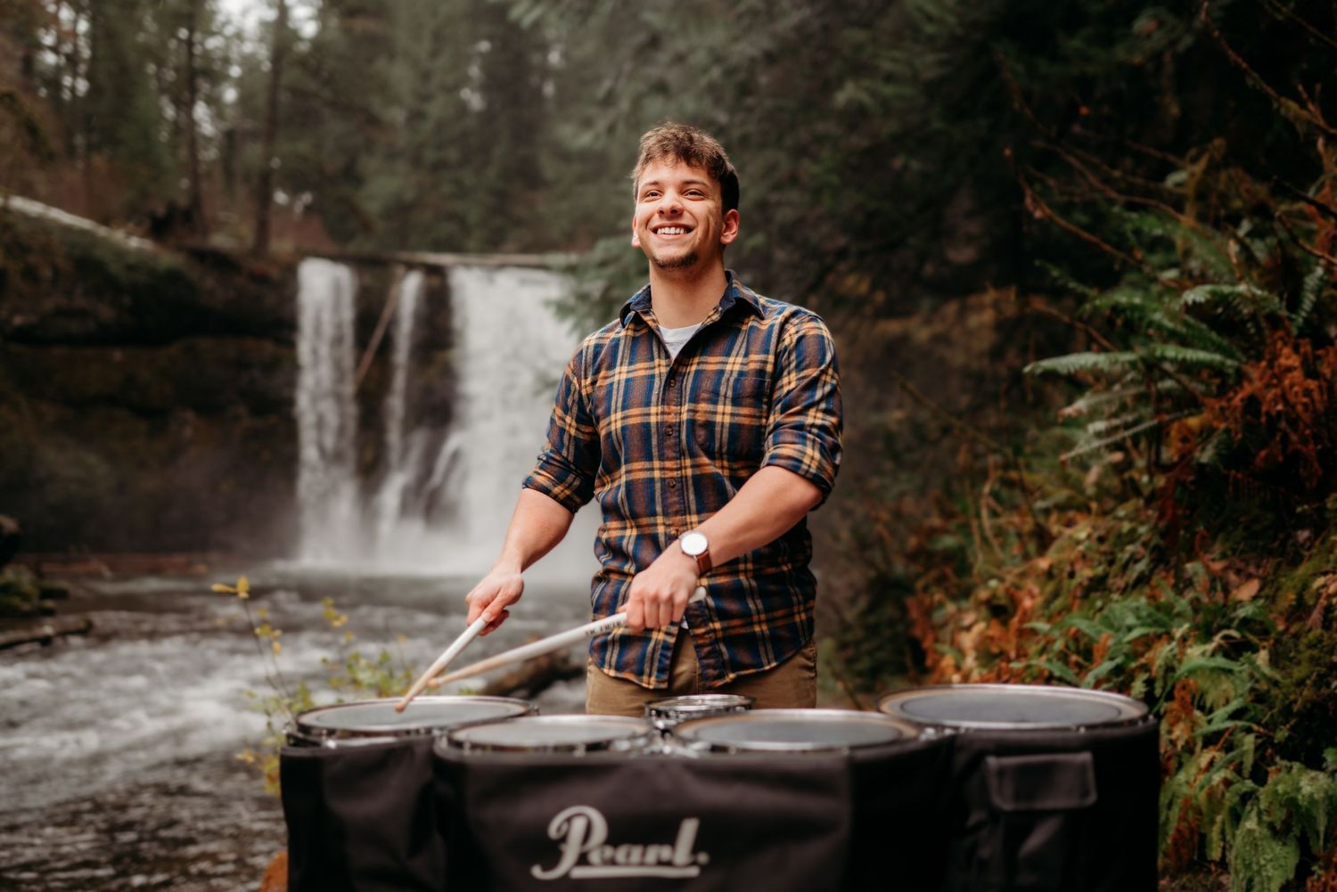 Senior boy playing drums at Silver Falls State Park in Oregon