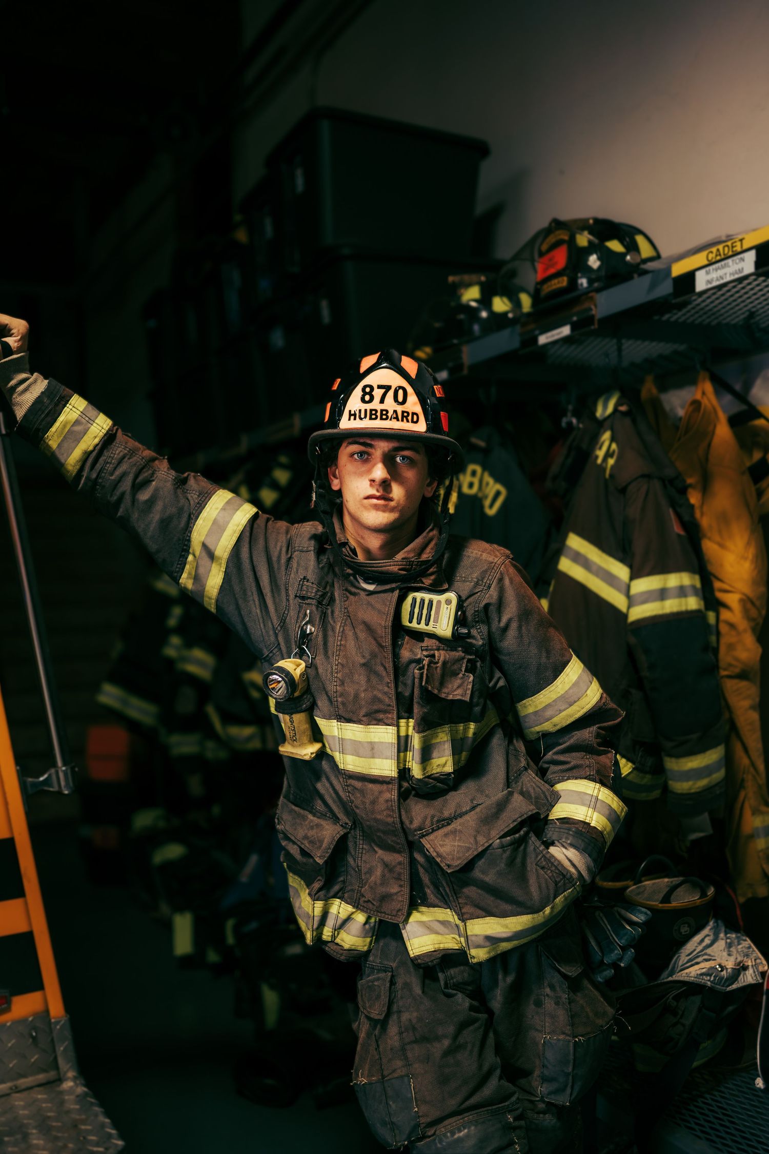 Senior boy wearing firefighter gear in a dramatic portrait