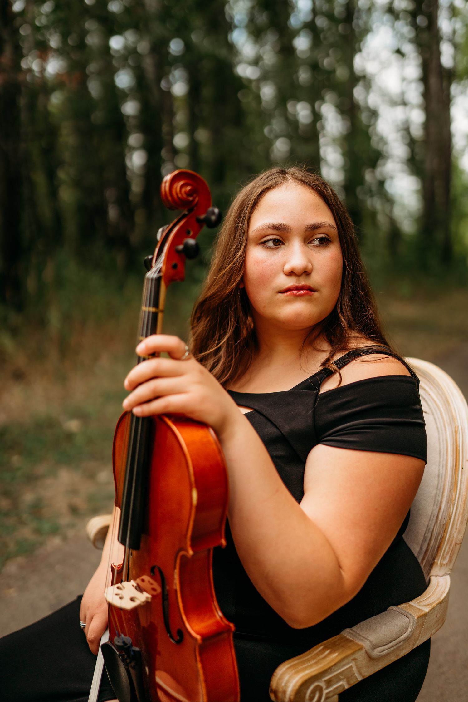 Senior girl holding a violin during an outdoor portrait session
