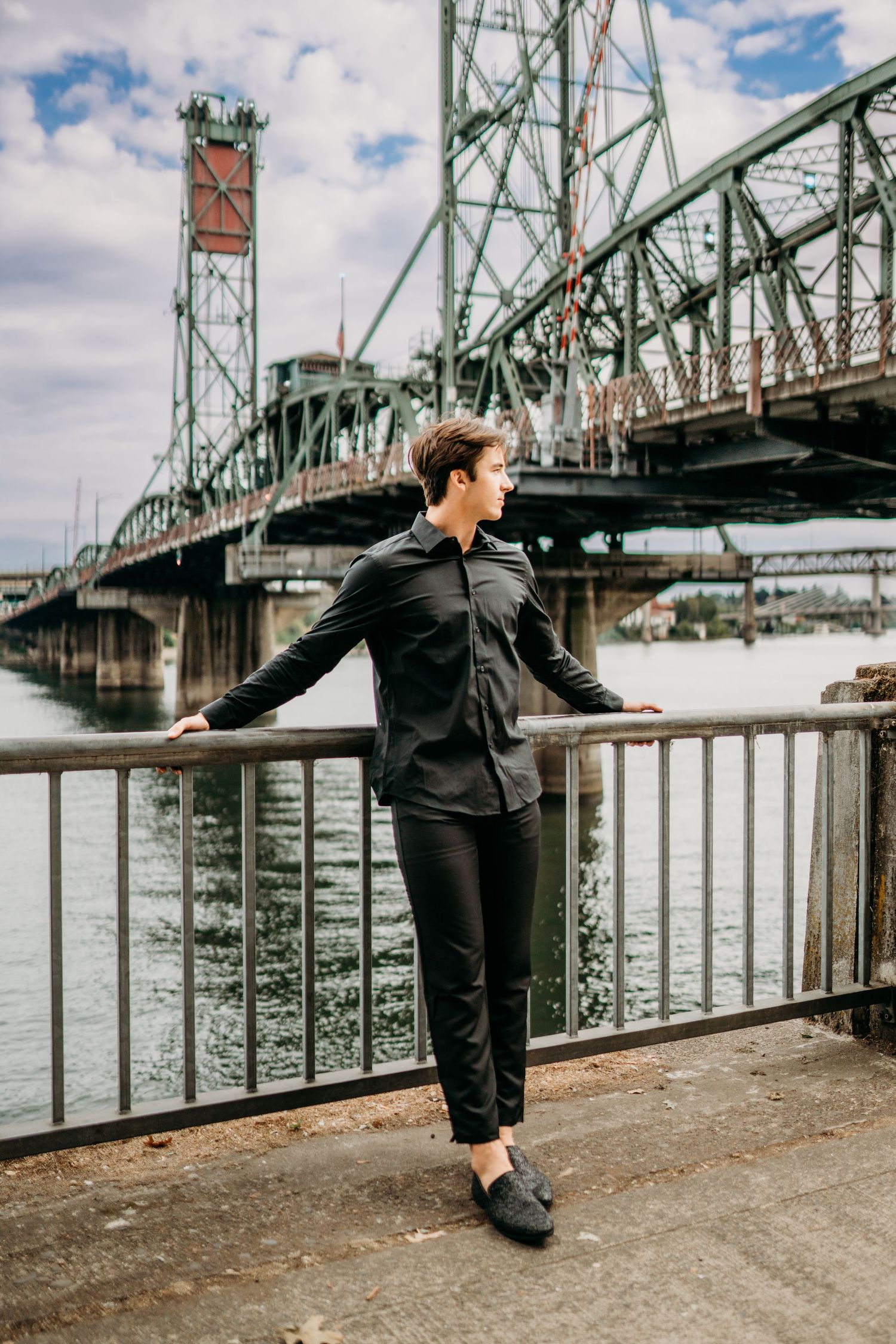 Senior boy standing near Tillicum bridge in Portland Oregon in an urban outdoor setting