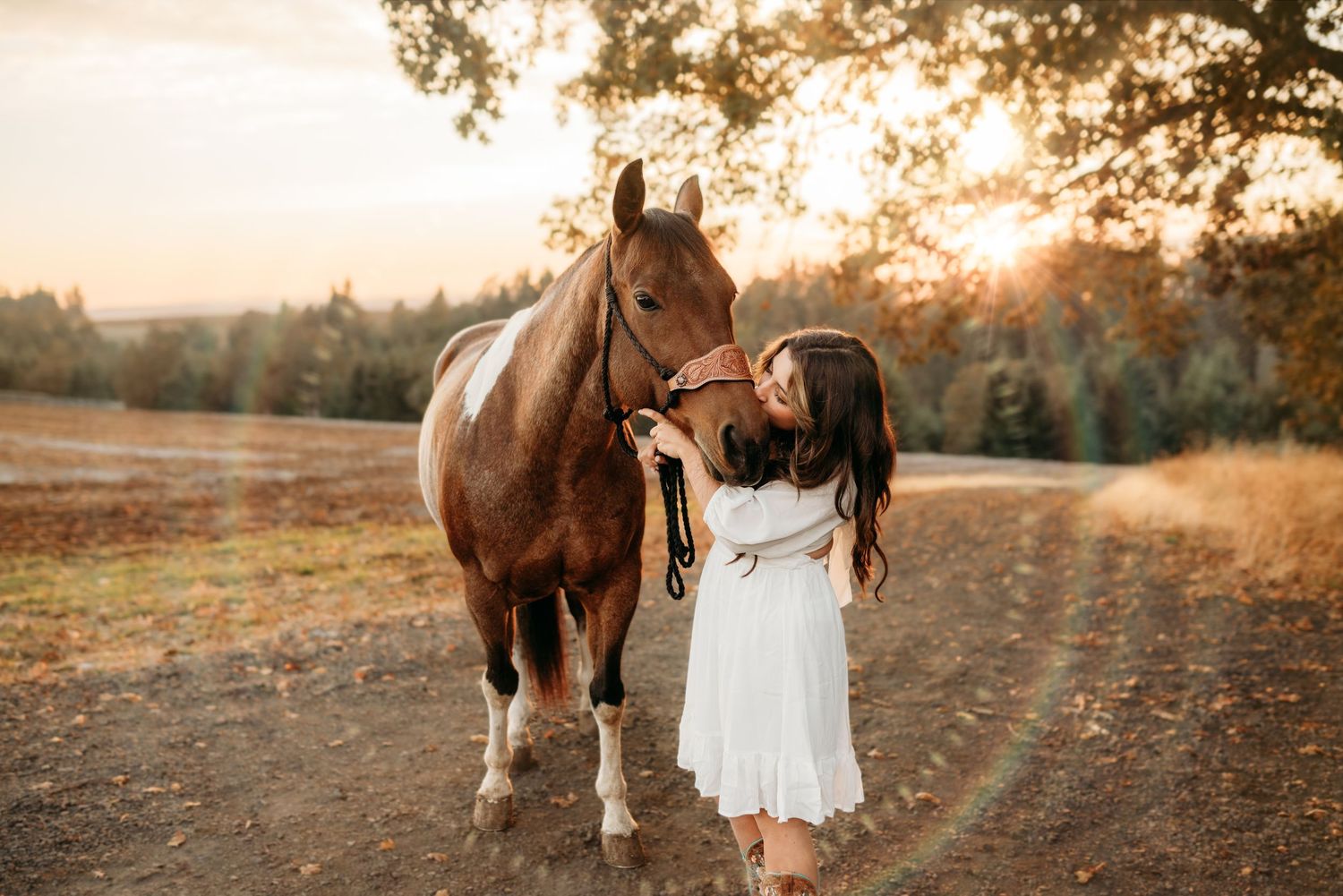 Senior girl walking with her horse during an outdoor portrait session