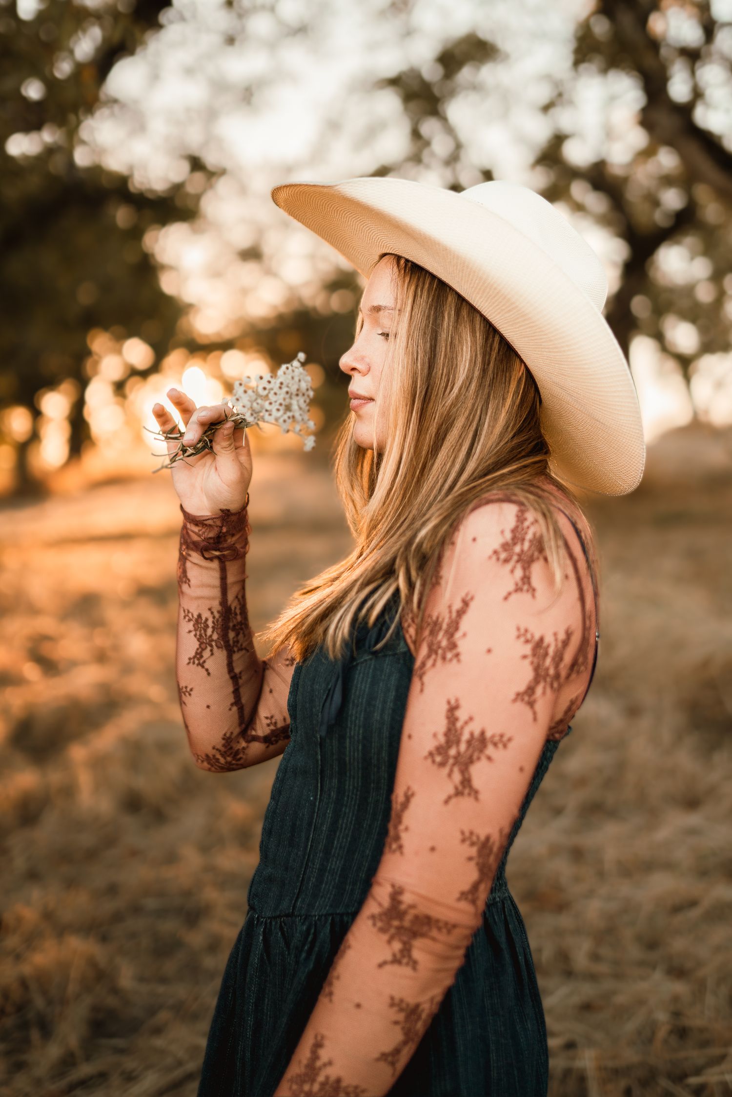 Senior girl wearing a cowboy hat during a sunset portrait