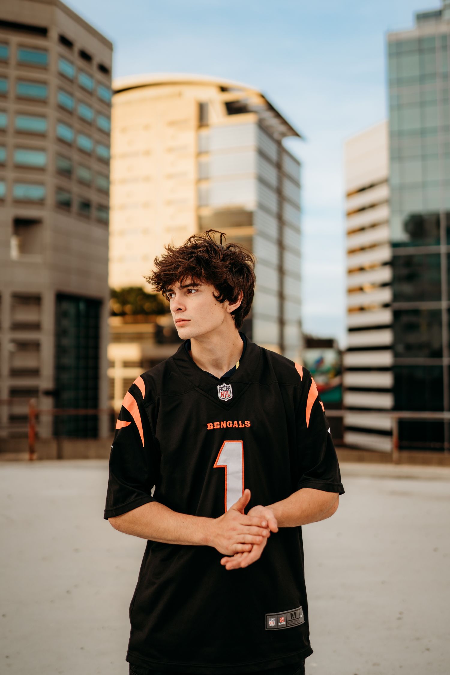 Senior boy in Portland Oregon wearing a football jersey