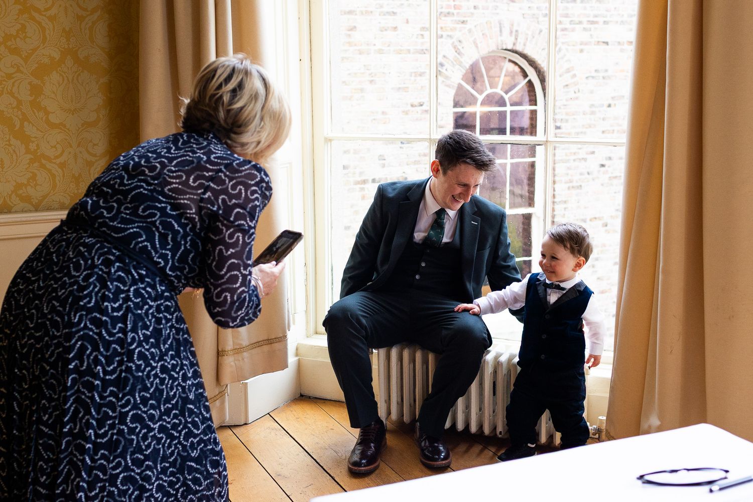 Sequence of candid moments captured by photographer in Dublin in a room with yellow wallpaper and ornate decor.