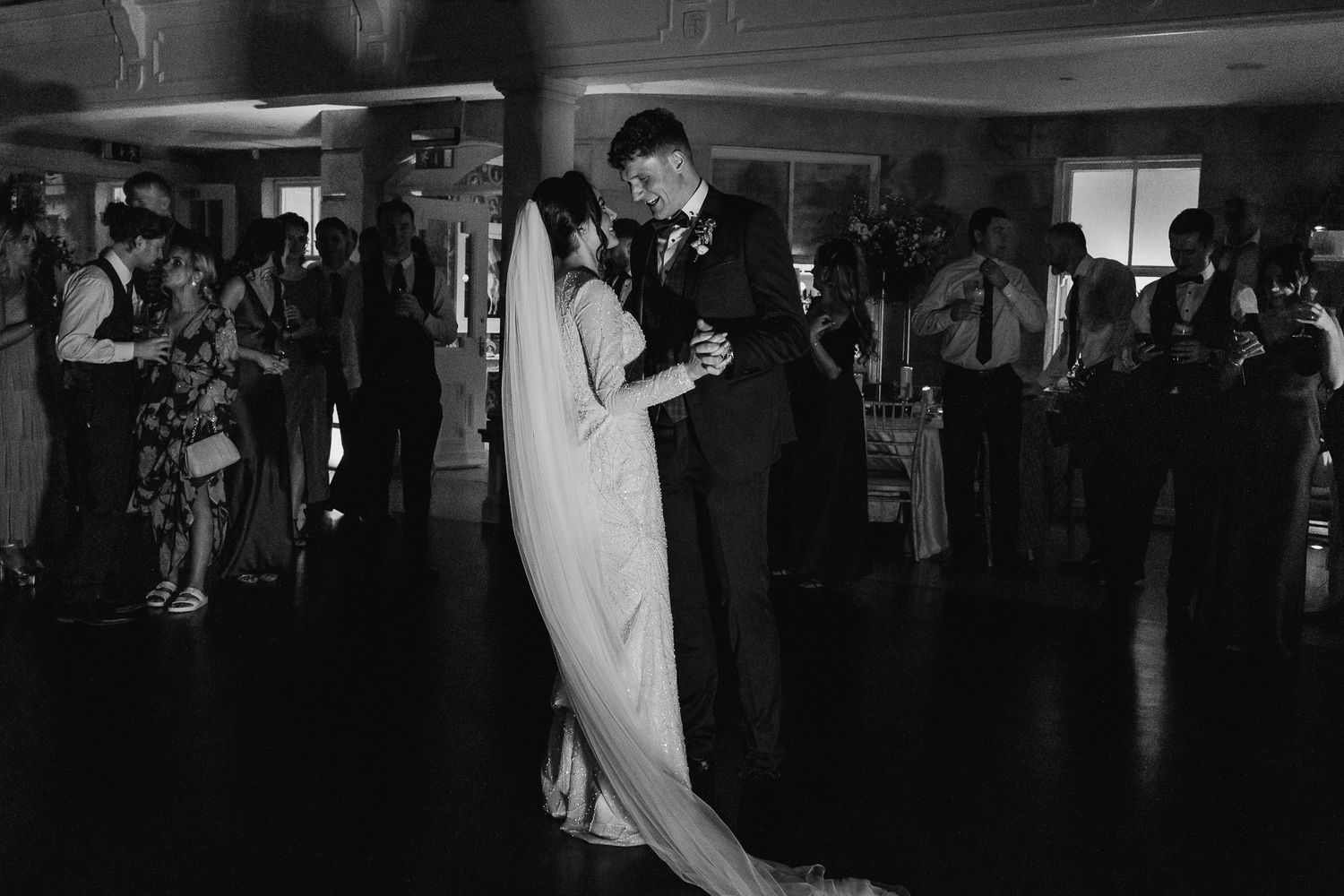 A couple shares their first dance at a wedding  in Dublin City hall in black and white photography by Dublin weddings photographer.