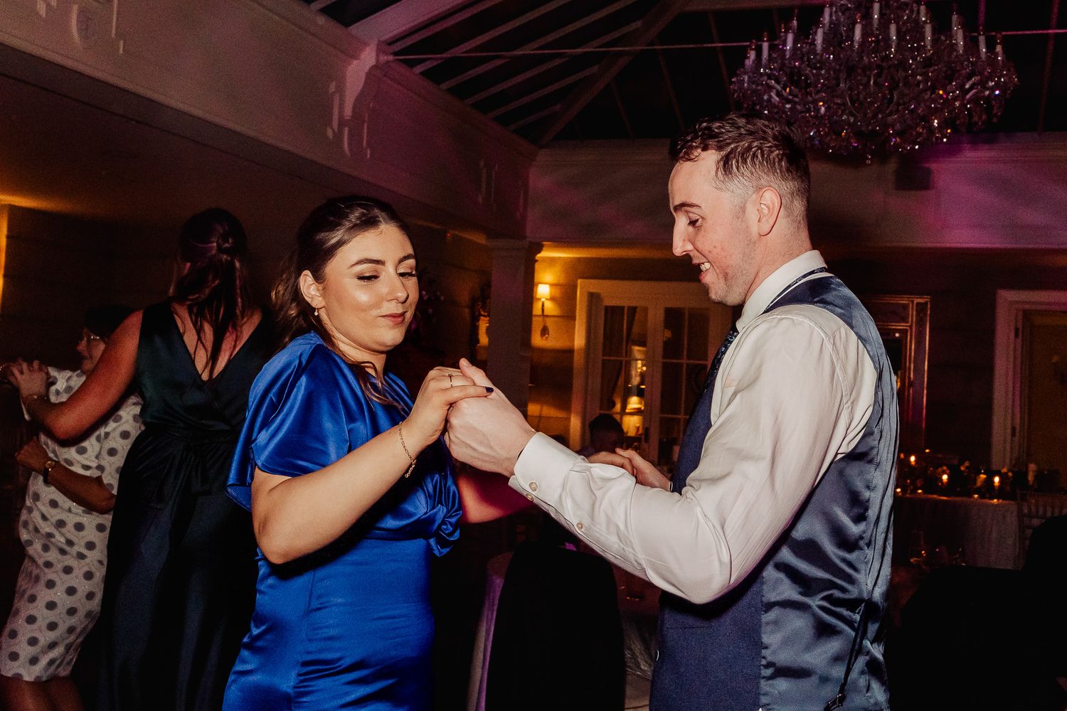 Dancers in formal attire hold hands during Dublin City wedding.