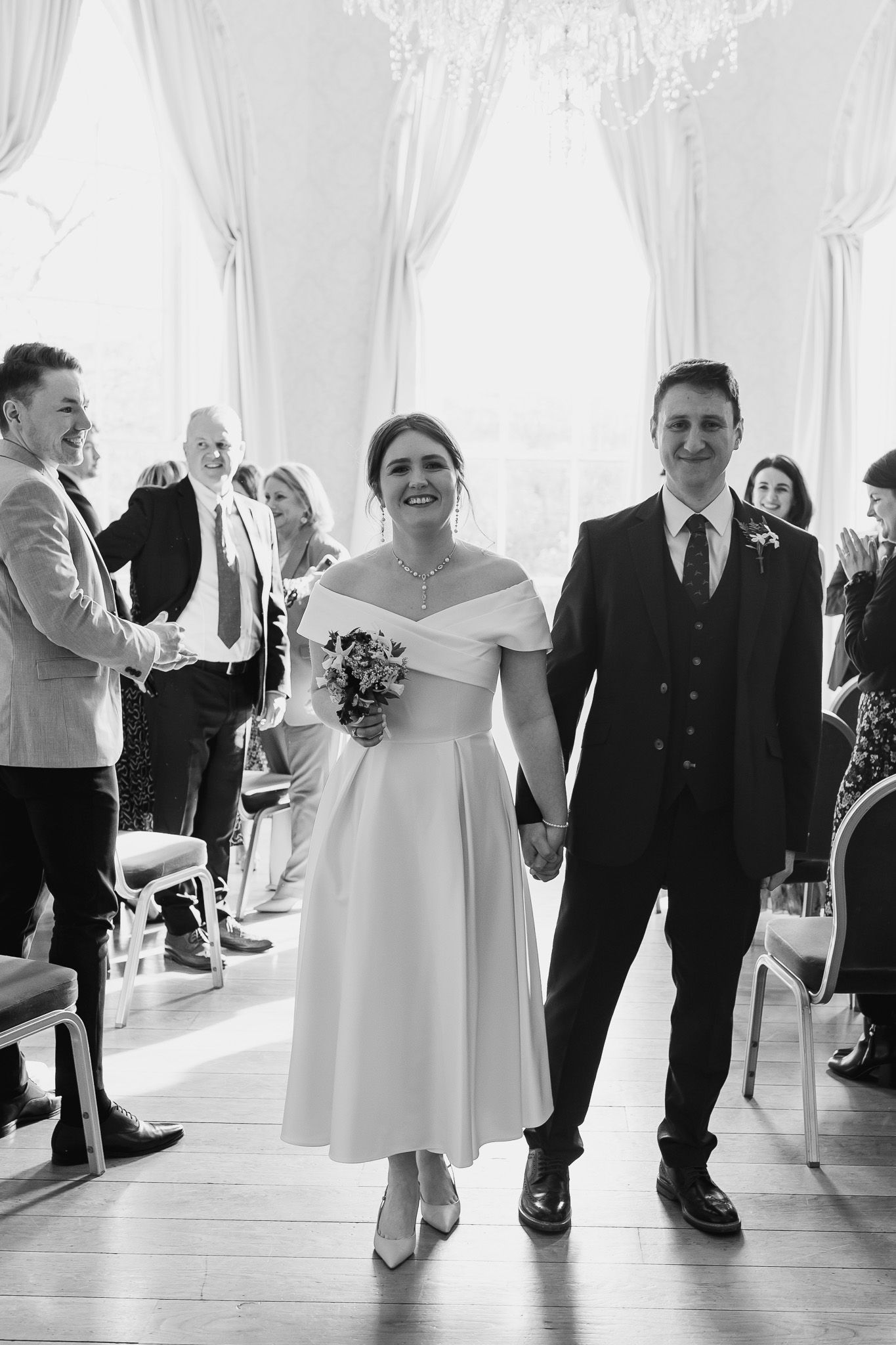 Dublin Wedding party dancing and celebrating in MoLI white room with chandeliers.