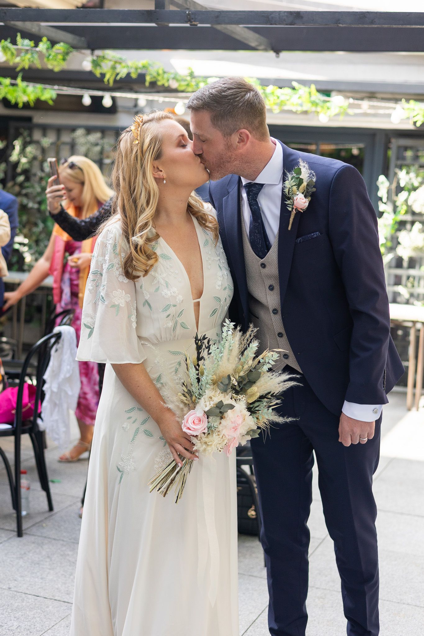 A romantic wedding moment in the Woolen Mills Dublin wedding ceremony with floral decorations.