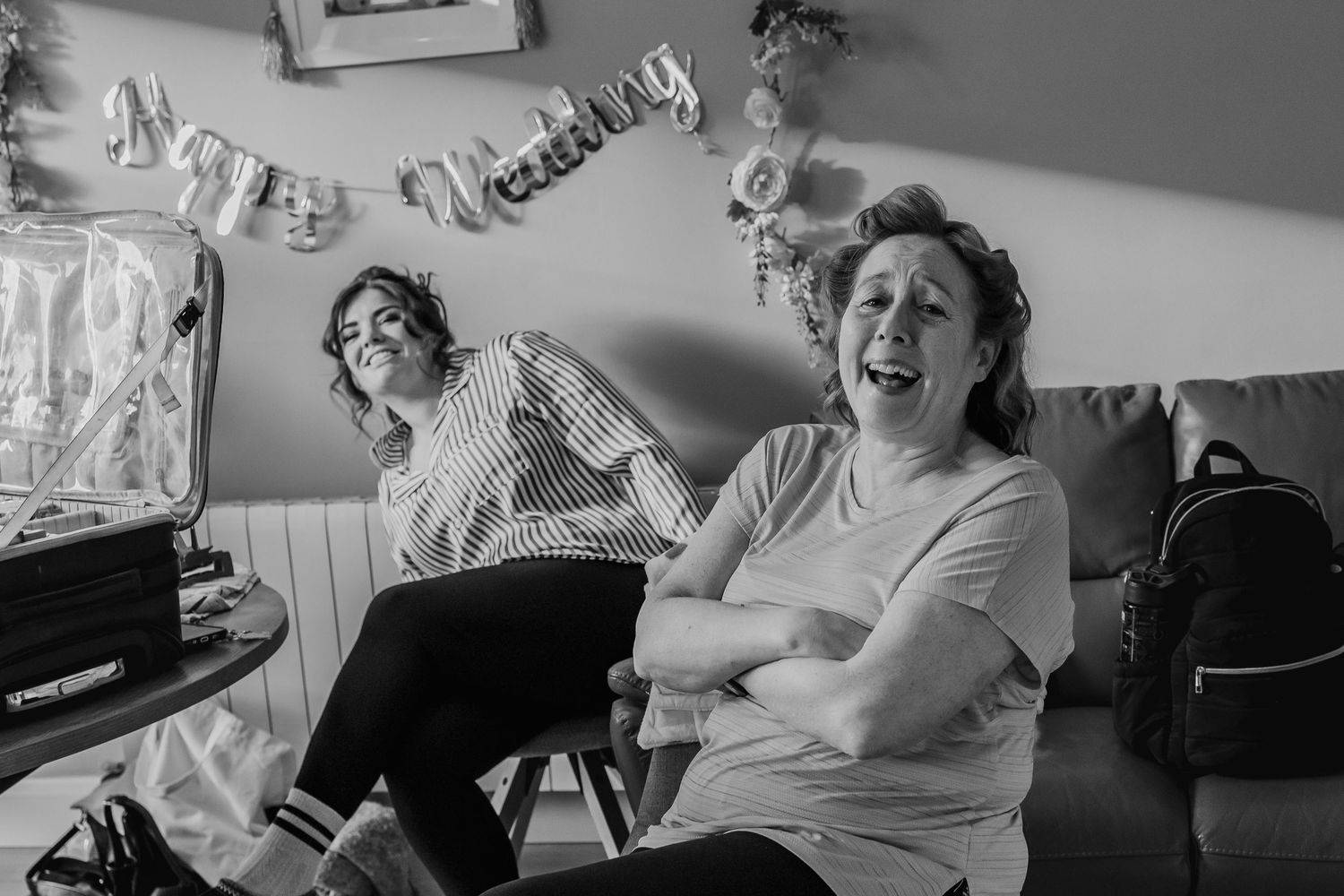 Candid black and white shots of guests relaxing during wedding celebrations.